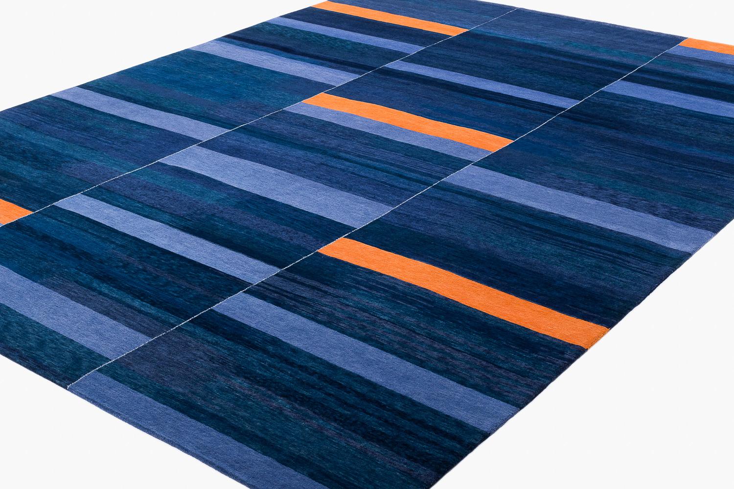 Inspired by nomadic weaves from Tibet, Nomads often wove together 3-6 individual narrow panels into one large carpet. What interested Joseph was the rhythm and syncopation and musical variation of these nomadic designs. The possibility to play with