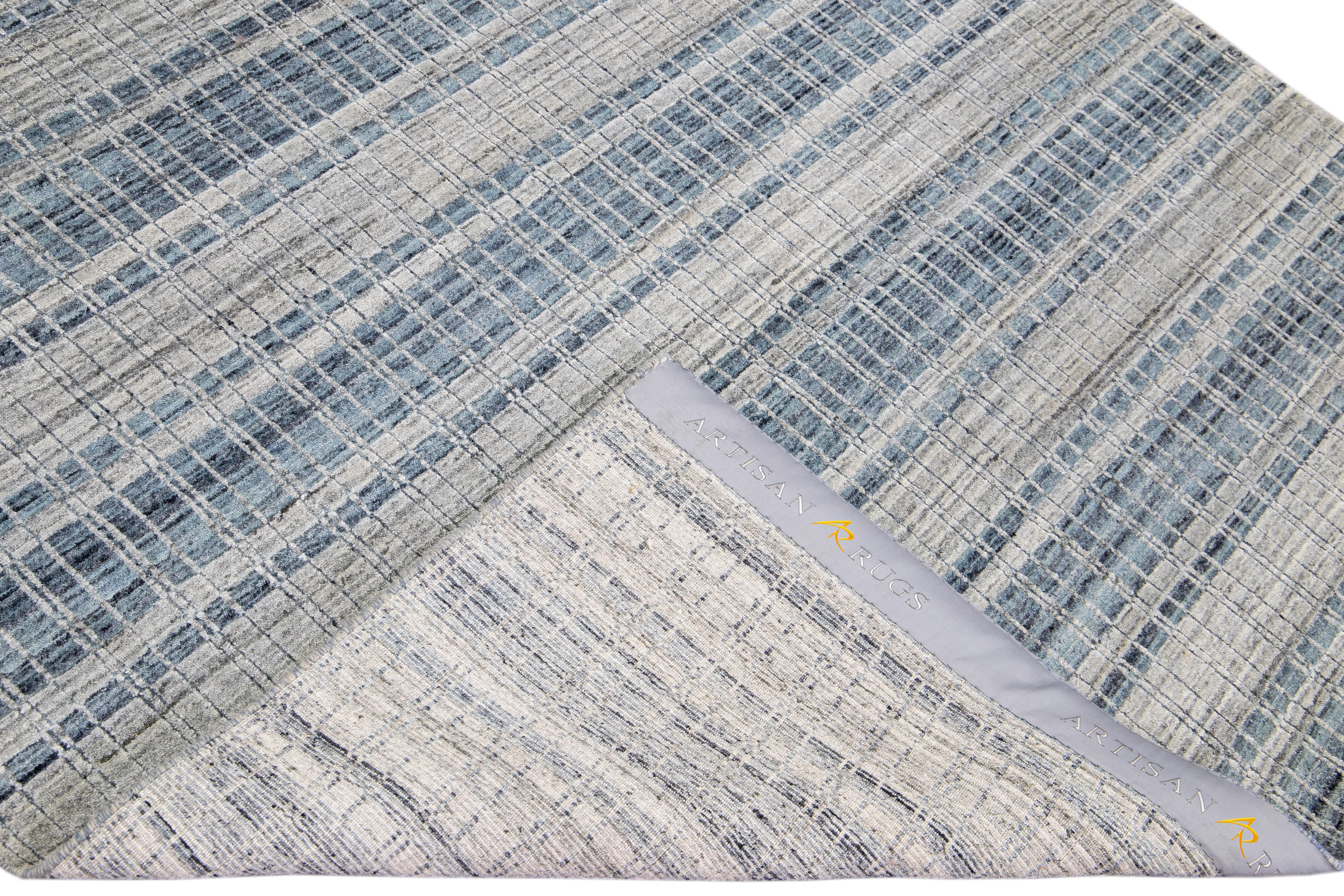 Beautiful modern Indian hand-knotted wool and silk rug with a blue and gray field featuring a gorgeous all-over geometric design.

This rug measures: 5'8