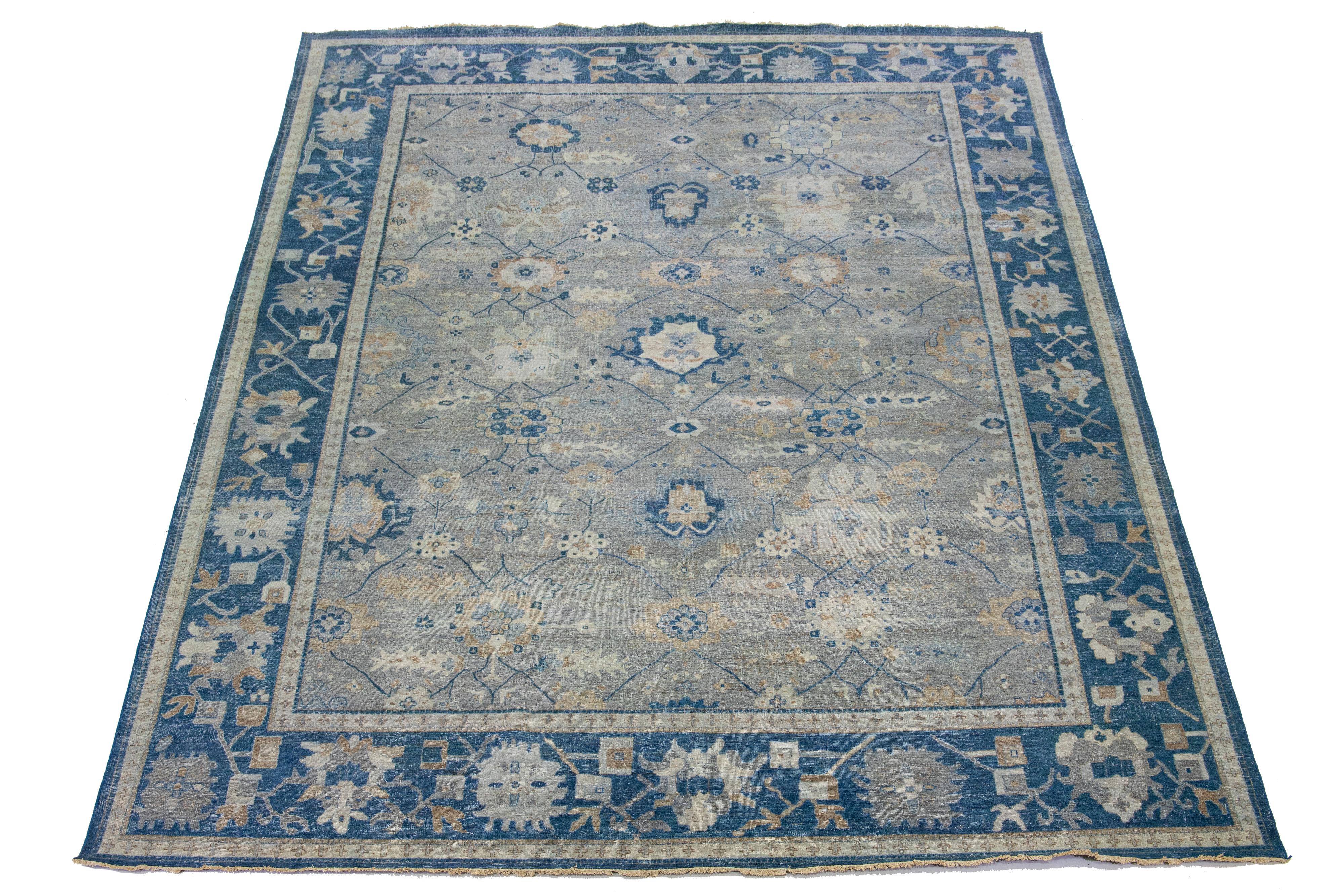 The Artisan line from Apadana infuses an exquisite antique style into any space. This hand-knotted rug exhibits a stunning all-over floral pattern with a gray color scheme and accents of blue. It measures 11' 11
