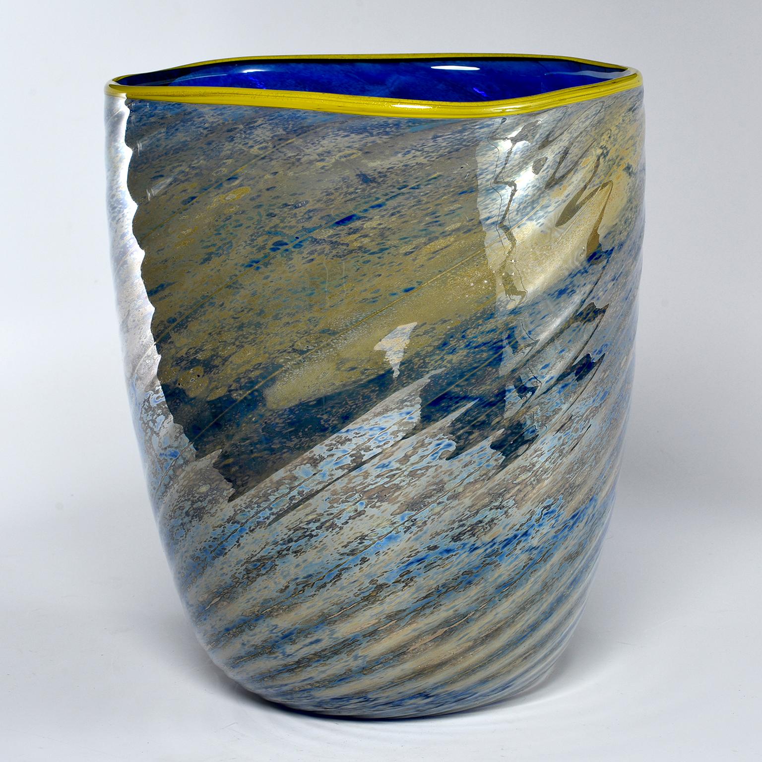Large art glass vase has a saturated cobalt interior with yellow lip and striated blue and gold outer surface. Dates from the 1990s. Unknown maker. Found in Italy.
