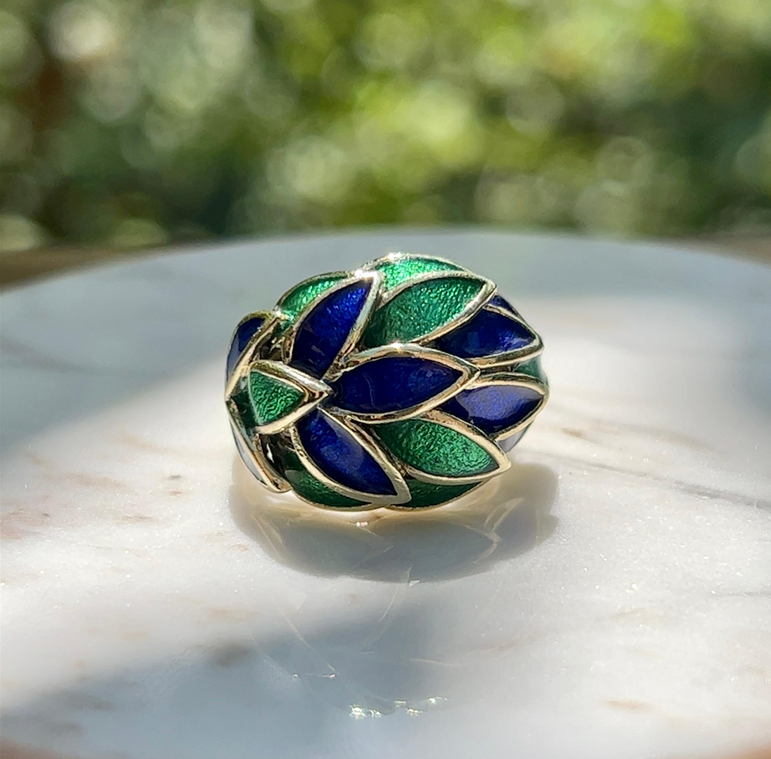 One 18-karat gold blue and green enamel dome ring in a finger size 5.25. 