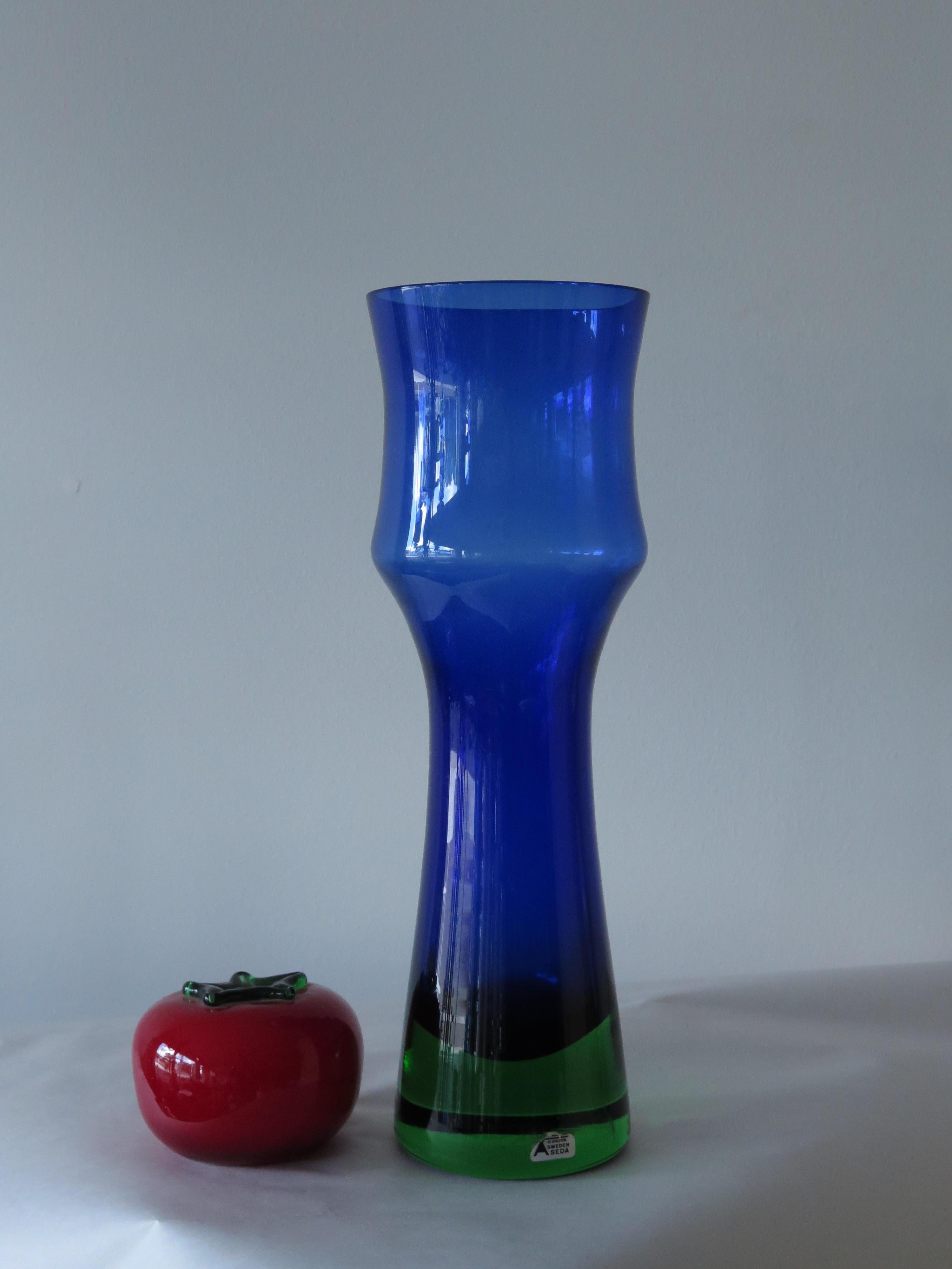 A tall, fluted, chalice shaped glass vase in blue and green by Bo Borgström for Åseda Glass works, Sweden, circa 1960s. Heavy green bottom, label partially intact.