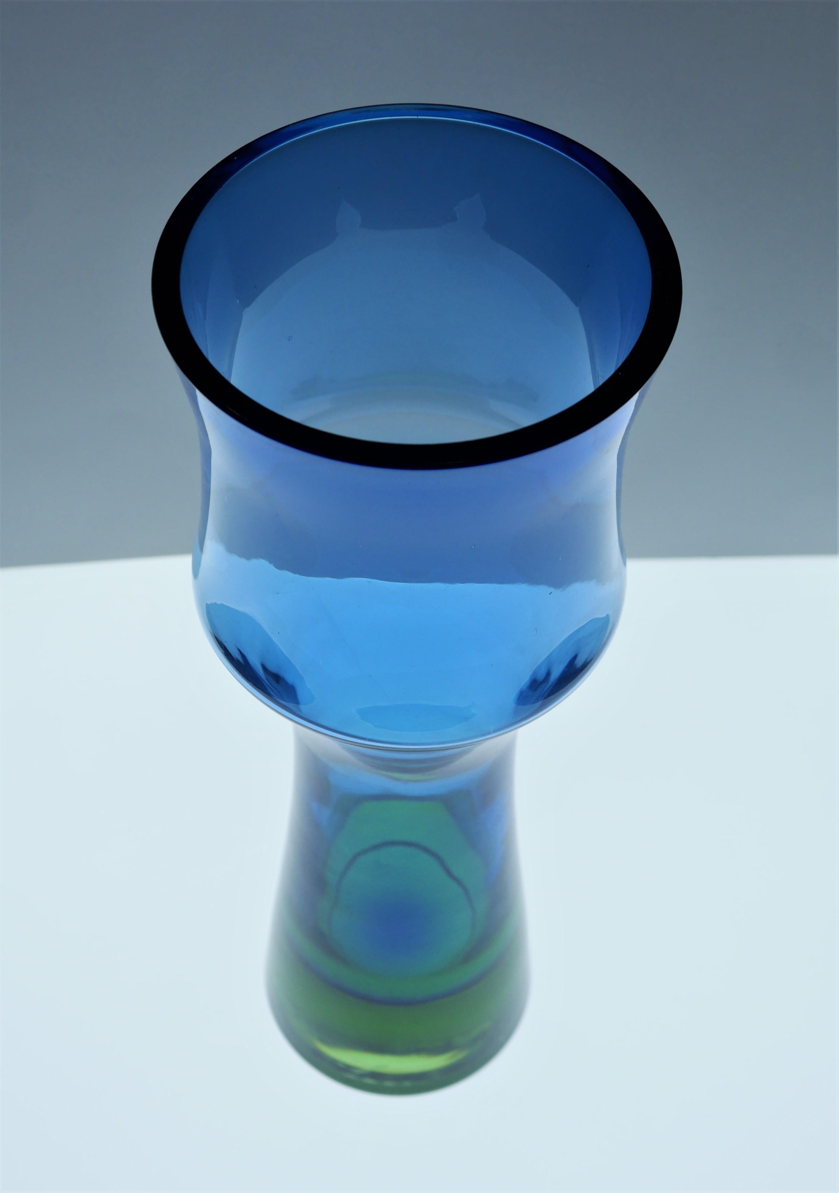 A tall, fluted glass vase in blue and green by Bo Borgström for Åseda Glass works, Sweden. This is very much a statement glass piece either on ots own or in a group, it will add to any setting. This vase has a very nice shape, but it is the colours