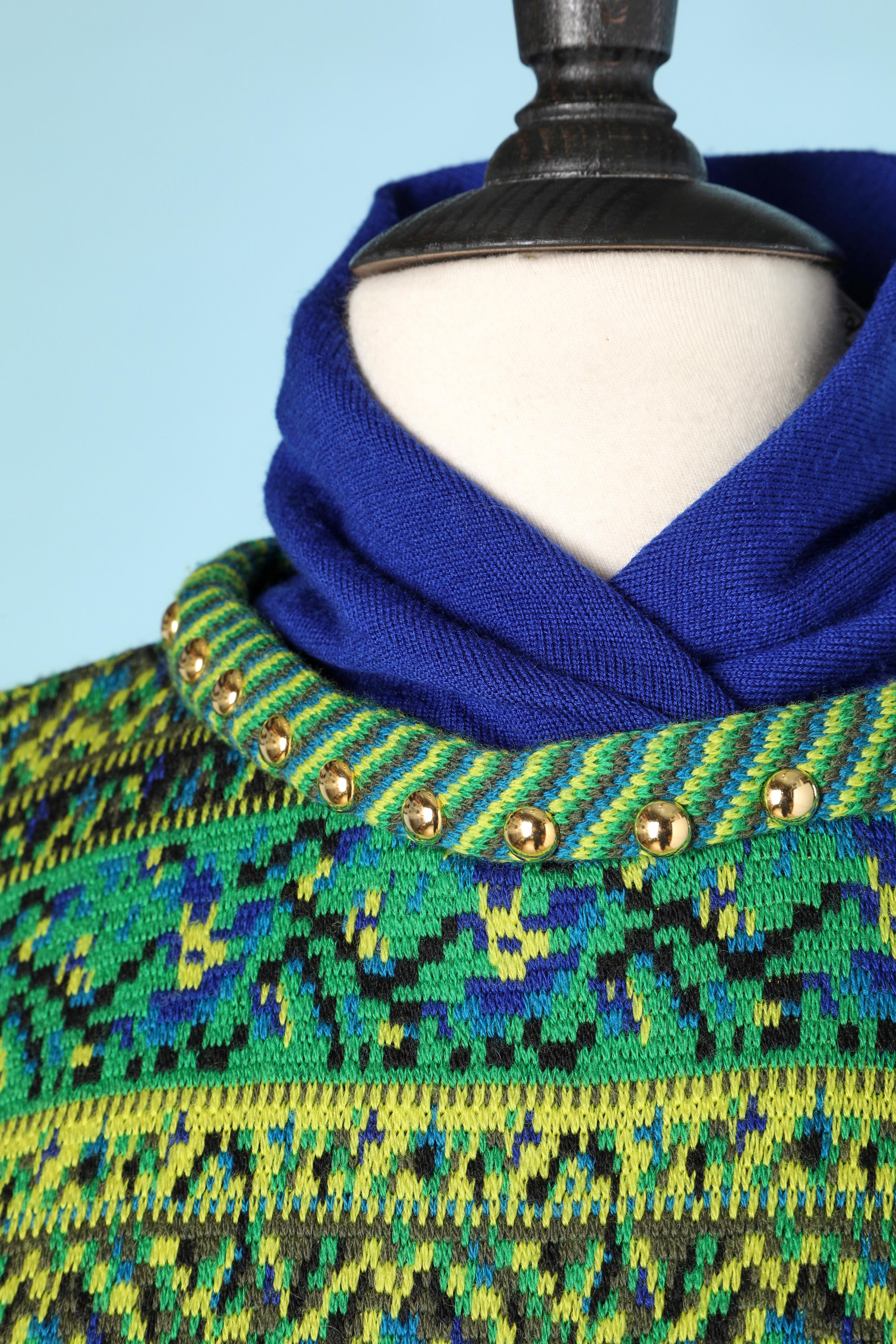 Blue and green jacquard sweater with gold studs and a blue knit collar 