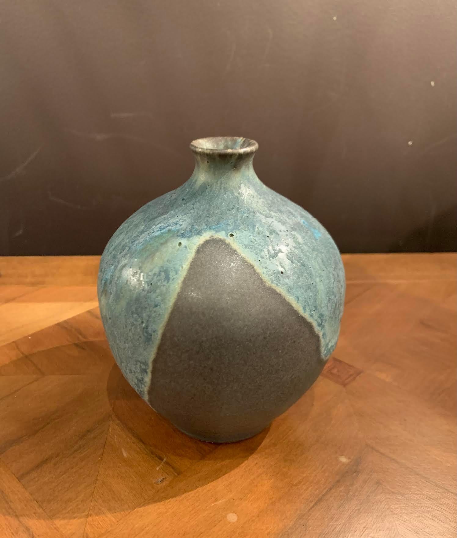Contemporary American Ceramist Peter Speliolpoulos stoneware vase.
Signed by the artist.
The matte blue glaze, paired with an agate glaze, react to create pieces with a mineral feeling, just unearthed.
One of a kind, hand thrown and glazed