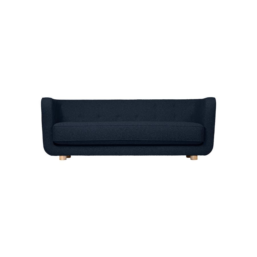 Blue and natural Oak Sahco Zero Vilhelm sofa by Lassen
Dimensions: W 217 x D 88 x H 80 cm 
Materials: Textile, Oak.

Vilhelm is a beautiful padded 3-seater sofa designed by Flemming Lassen in 1935. A sofa must be able to function in several