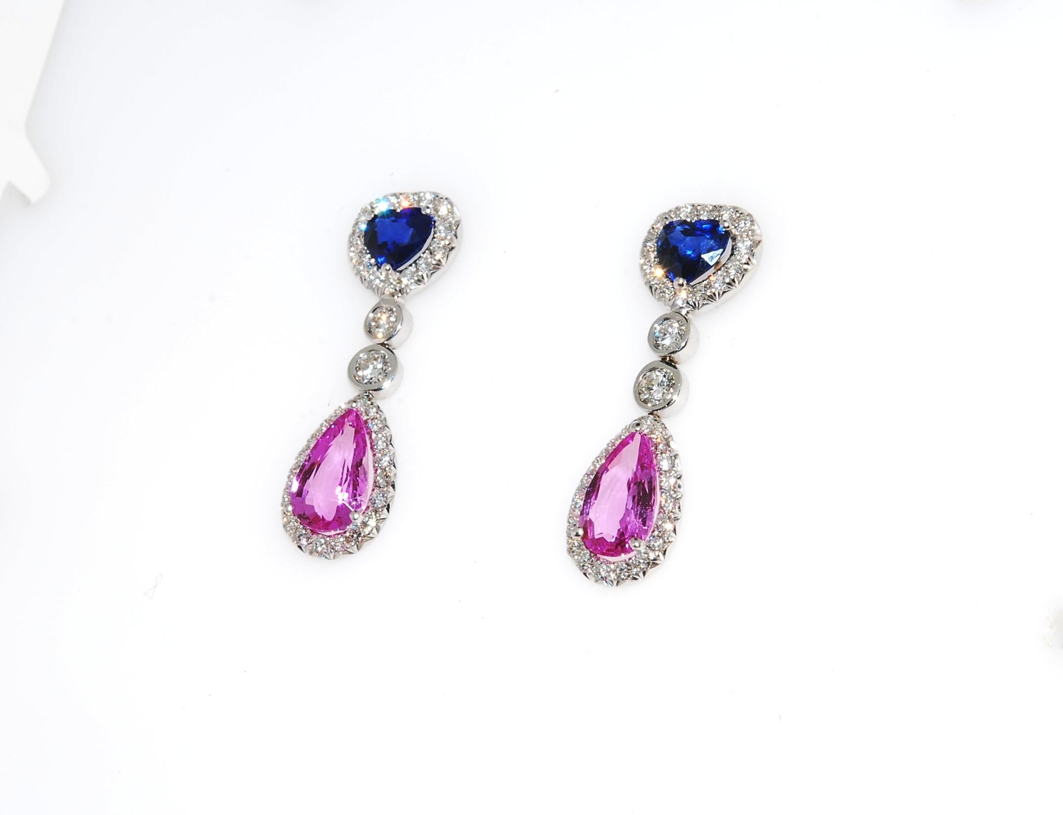 Blue and Pink Sapphire - two heart shaped Ceylon blue sapphire on top of two pear shaped pink sapphires each in a halo of F VS quality diamonds in a drop or dangle style with friction back posts. The Ceylon blues weigh 1.70 ctw, and the pinks weigh