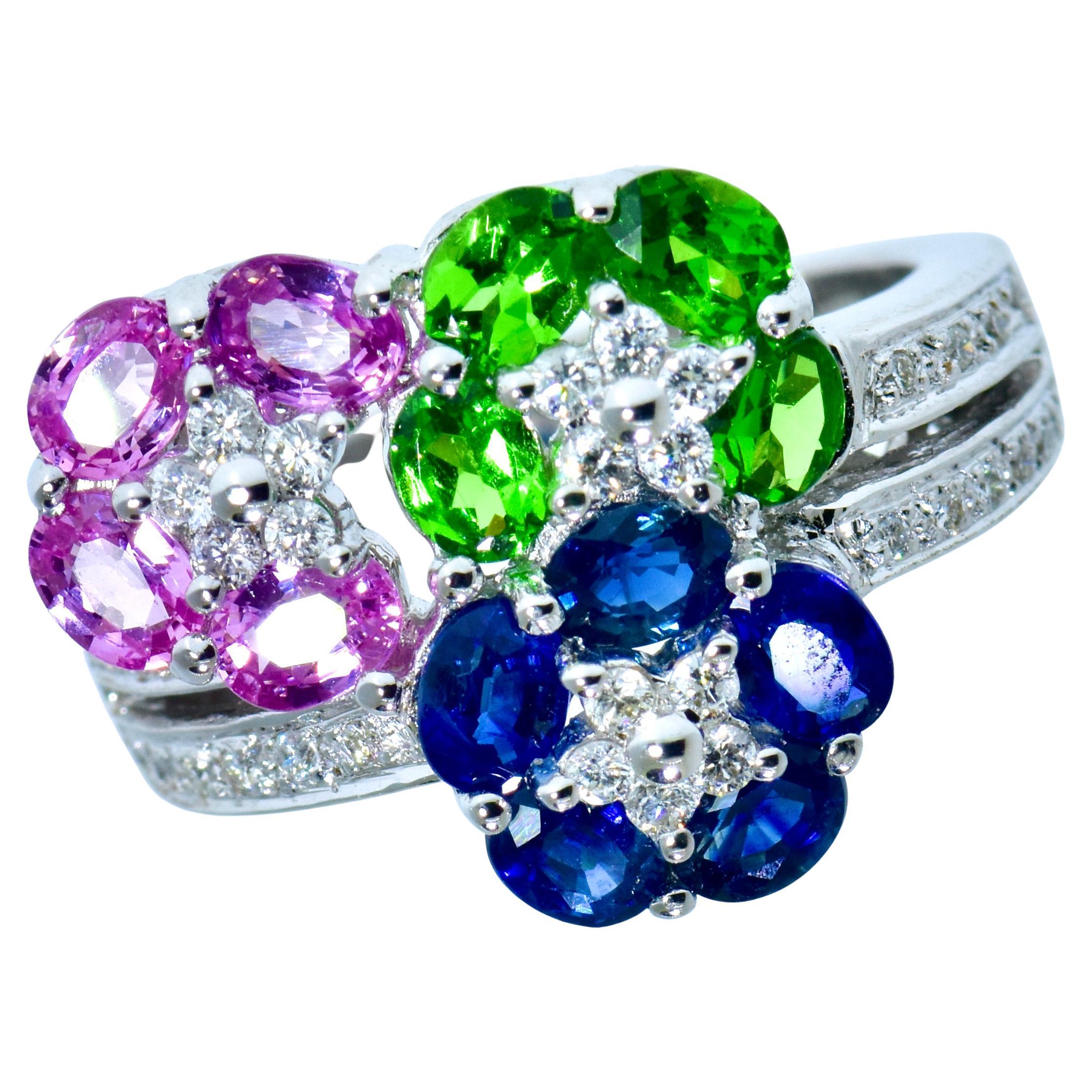 Pink Sapphires, Blue Sapphires and bright green Tsavorites with white brilliant cut diamonds all create a very fine contemporary ring by the famous firm of LeVian.  The  fine bright and clean oval cut sapphires (both pink and blue), weigh totally an