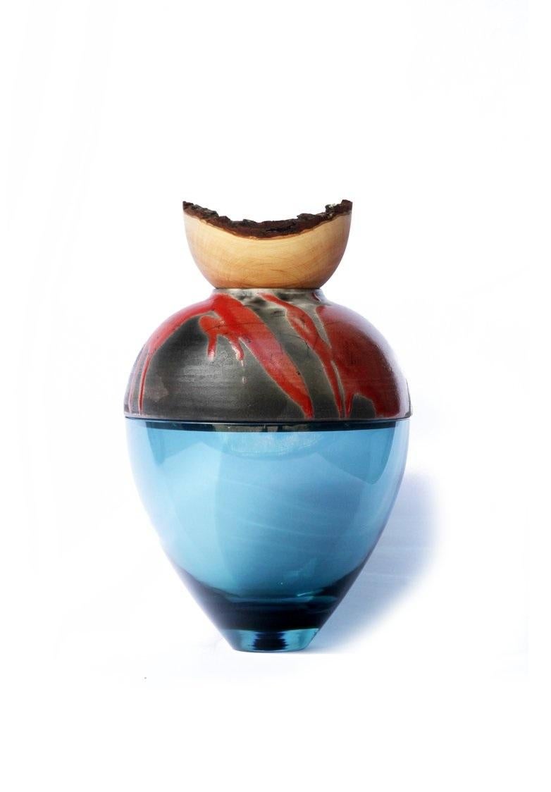 Blue and red butterfly stacking vessel, Pia Wüstenberg
Dimensions: D 20 x H 24
Materials: glass, wood, ceramic
Available in other colors.

A delicate piece with a mind of its own: beautiful patterns emerge from the glaze and the fire, making