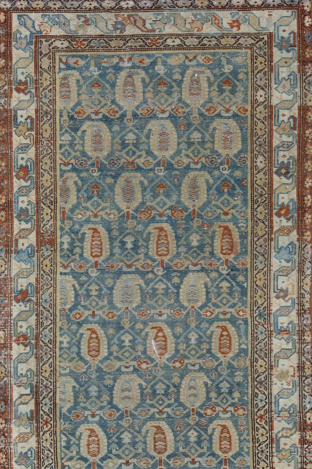 Antique Malayer Runner

Circa 1920

Pile: Low

Good condition. Beautiful vibrant blue field with a large scale boteh pattern in beige and rust. 

Wear notes: none

Wear Guide:
Vintage and antique rugs are by nature, pre-loved and may show