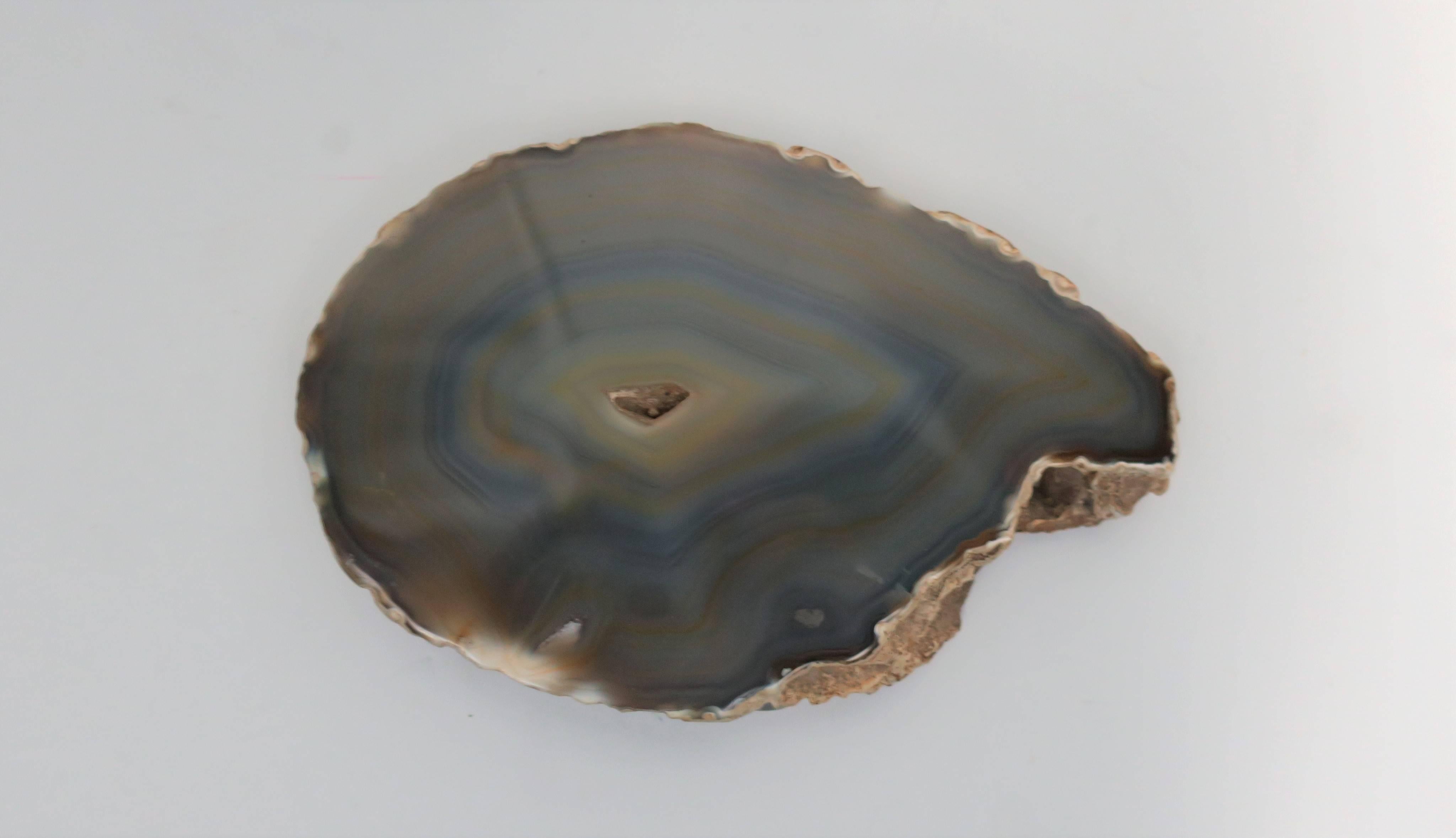 A beautiful and substantial polished natural agate onyx piece in shades of tan or sand and blue. Piece may be used as a paperweight, decorative object on a shelf, table, desk, etc., or as a display piece. 

Piece measures: 1.25 in. H x 4.75 in. D x