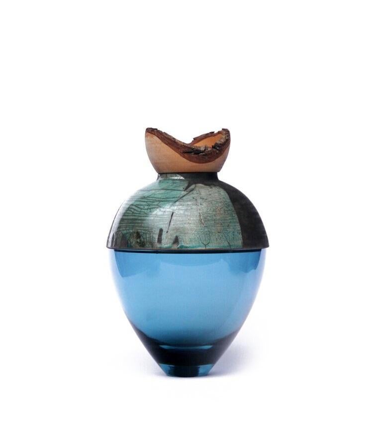 Blue and turquoise butterfly stacking vessel, Pia Wüstenberg
Dimensions: D 20 x H 24
Materials: glass, wood, ceramic
Available in other colors.

A delicate piece with a mind of its own: beautiful patterns emerge from the glaze and the fire,