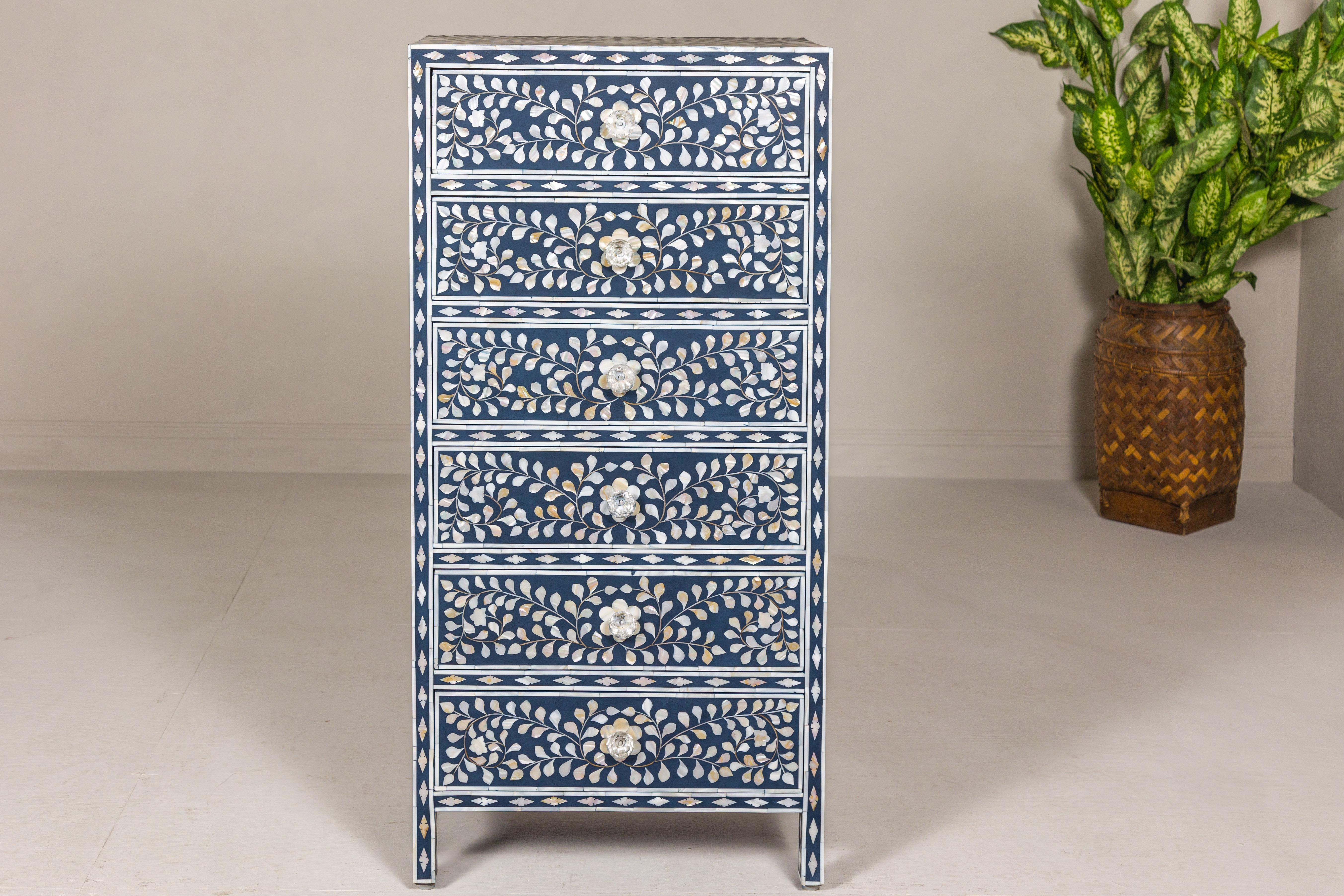 A blue and white Anglo-Indian style tall chest  with mother-of-pearl inlay, six drawers and scrollwork motifs. Introducing this stunning Anglo-Indian style tall chest, a sublime union of form and function that effortlessly marries the charmingly