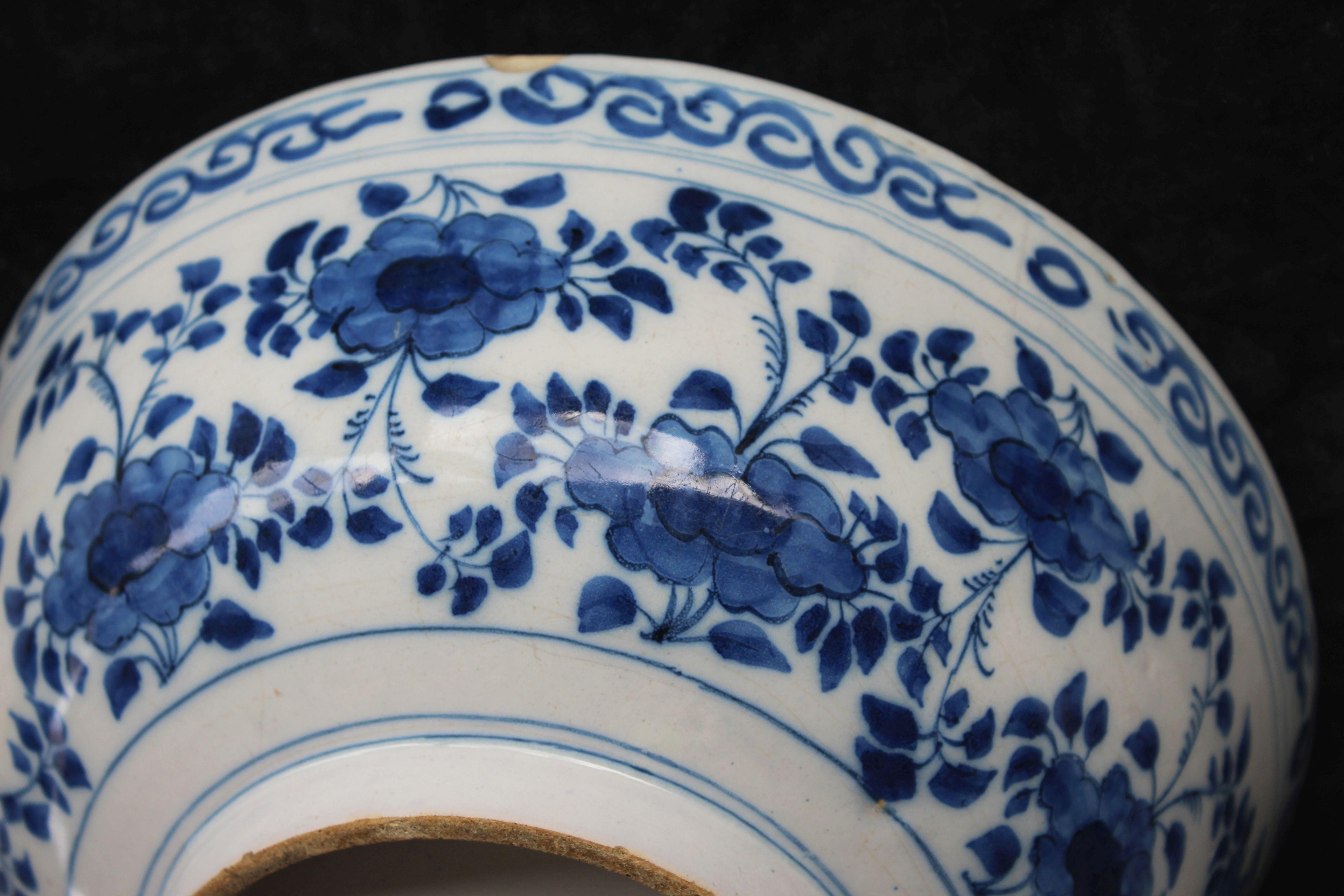 Blue and white bowl Delft, 1690-1710

The bowl is painted on the outside with a continuous garland of flowers under a scroll border. The inside is boldly painted with a flying bird under clouds, above a simplified ground. This schematic decoration