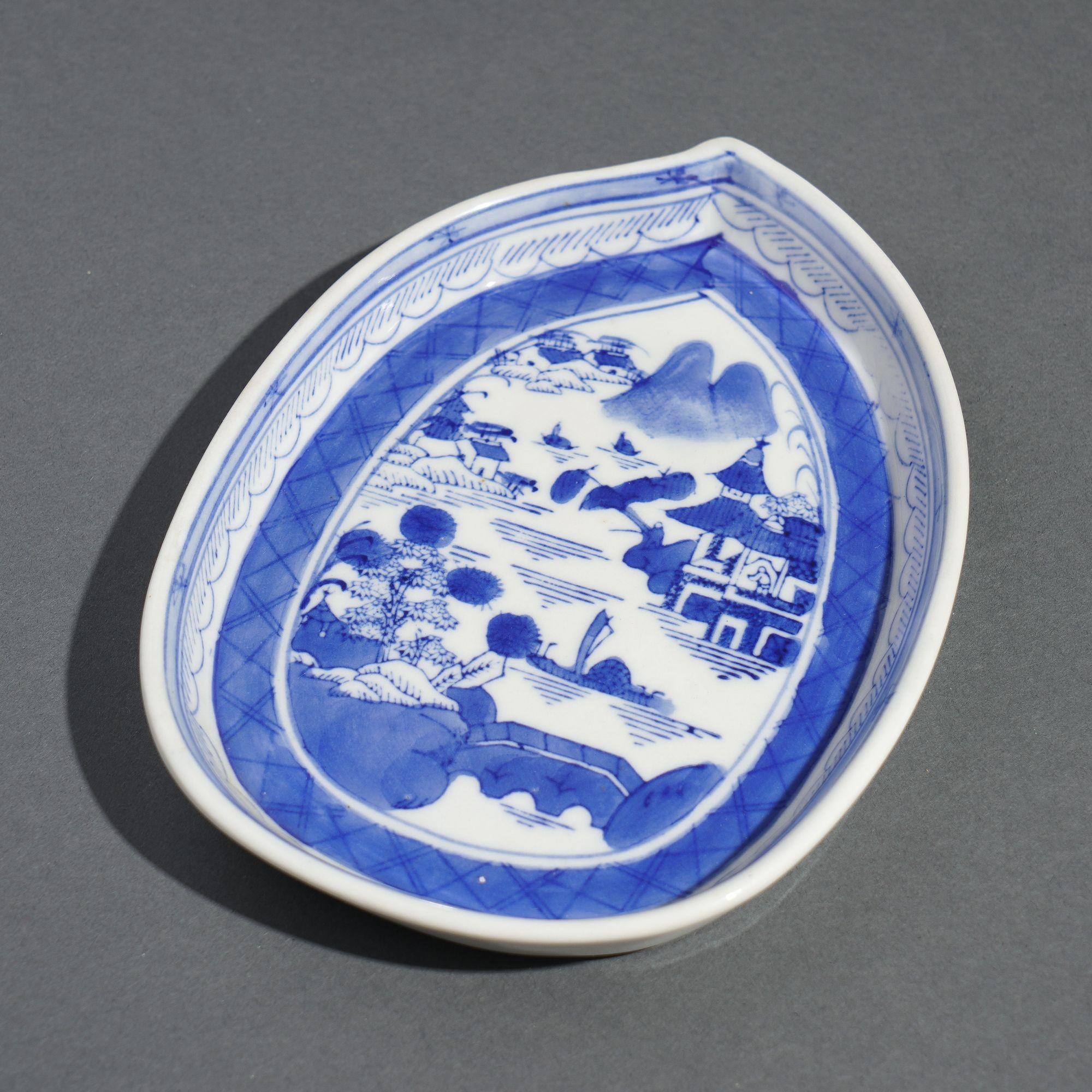 Blue and White porcelain teapot stand in a mulberry leaf shape. Canton, present day Guangzhou, is the capital city of the province of Guangdong in Southern China. Sericulture has been traditionally important in this region of China, and that might