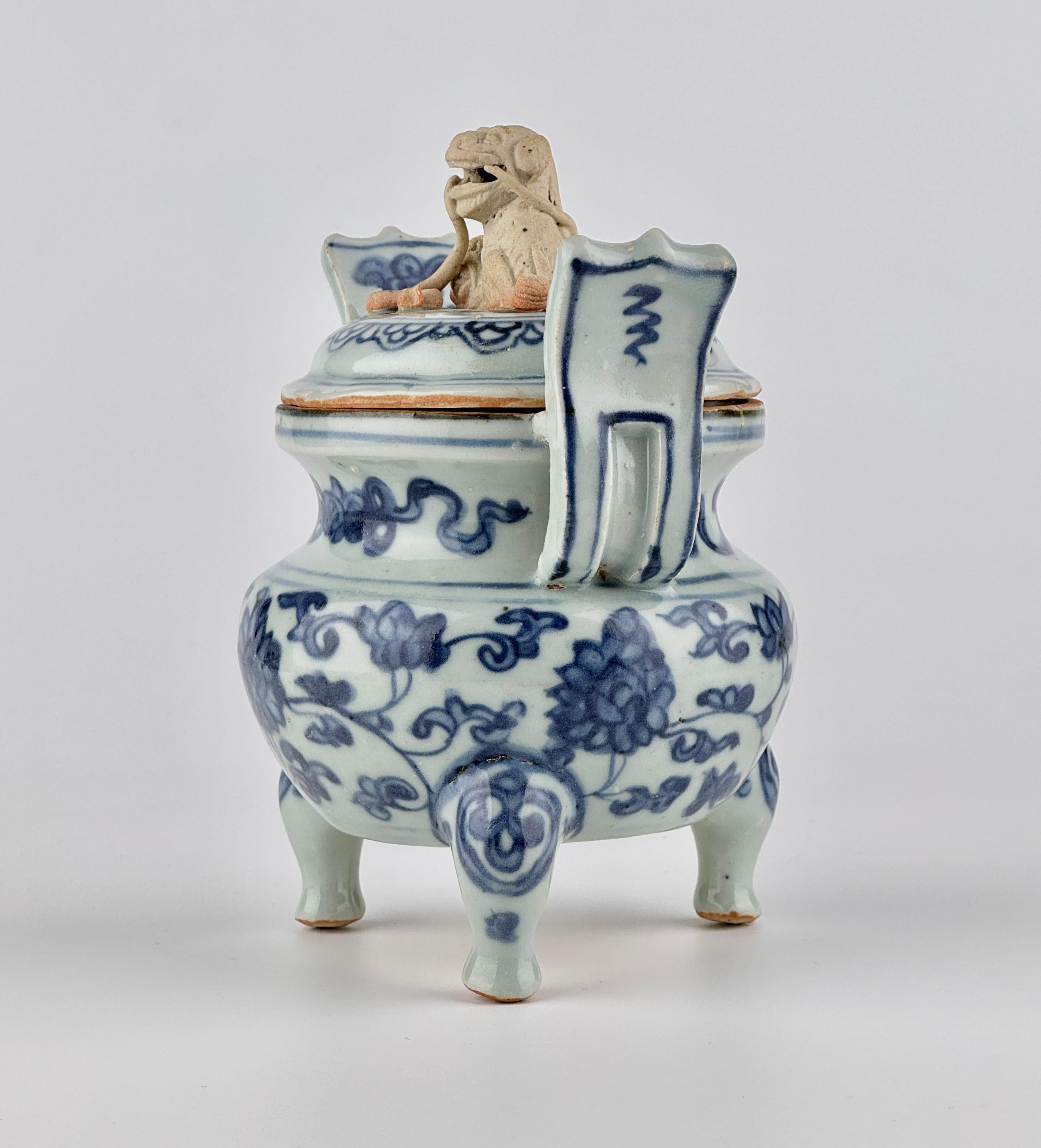 This tripod censer is believed to date from the reign of the Zhengde Emperor (1506–1521) to the early years of the Jiajing Emperor (1522–1540s) during the Ming dynasty. The cobalt blue pigment appears in a relatively soft grayish-blue tone, showing