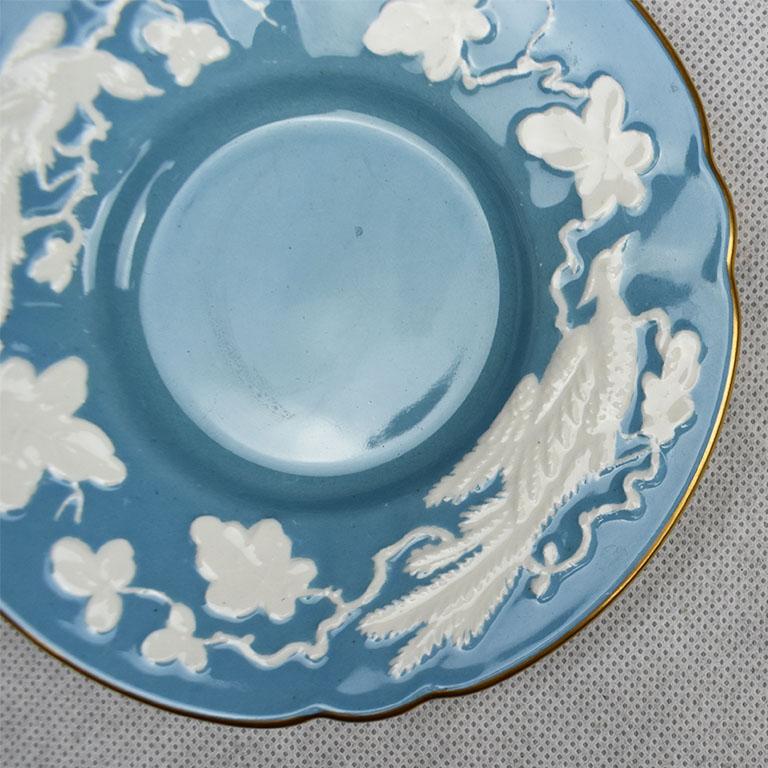 Lovely blue and white Royal crown derby saucer or catchall. This ceramic piece features white phoenix birds and floral designs around the sides and gold detail around the scalloped edges. Signed in verso 