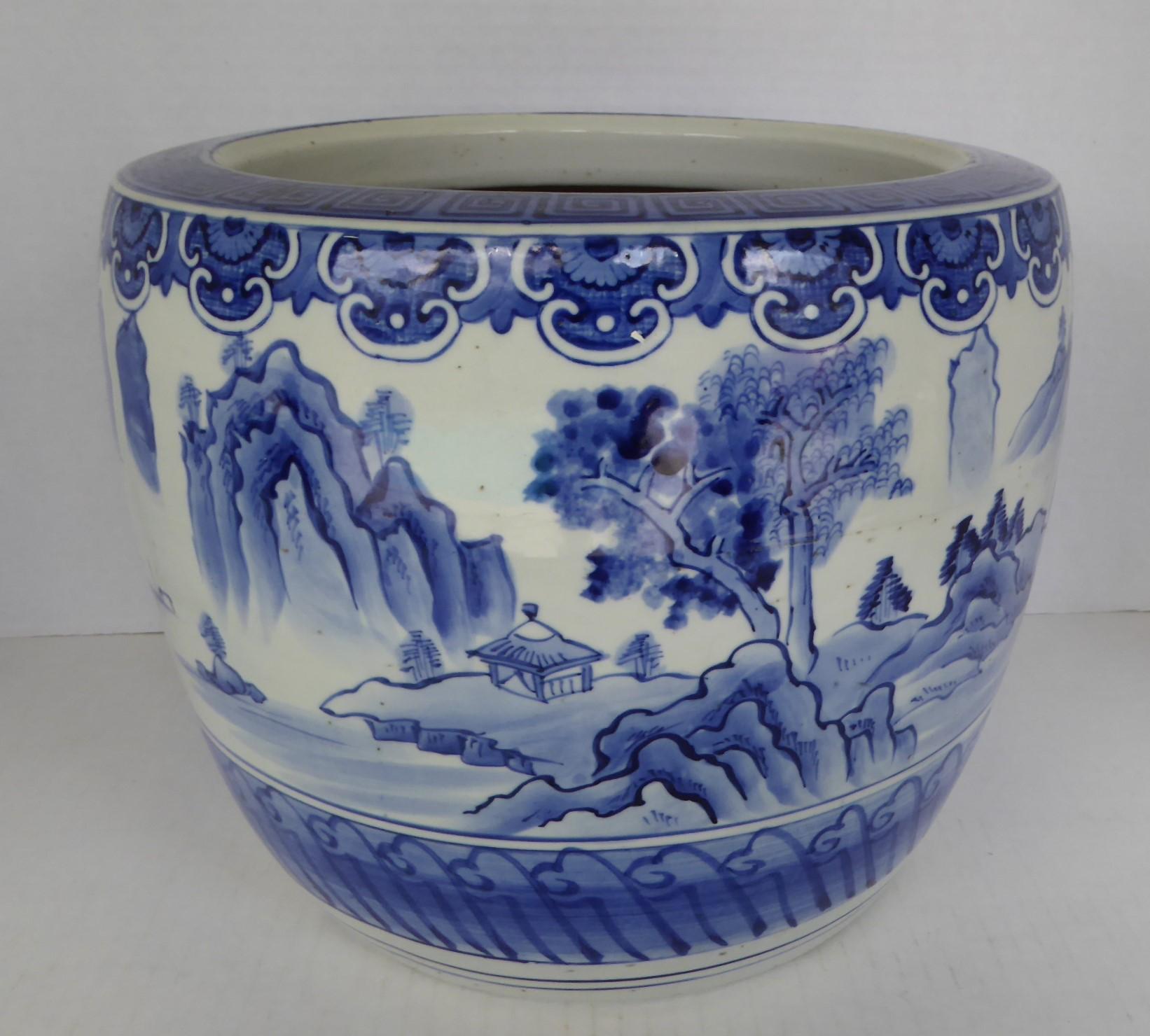 REDUCED FROM $550....Lovely Japanese Hibachi from the 1960s in blue and white ceramic. The hand painted depiction of a village near a body of water with a mountainous terrain, looks like the Peaks of Huangshan China, in the background. As in with