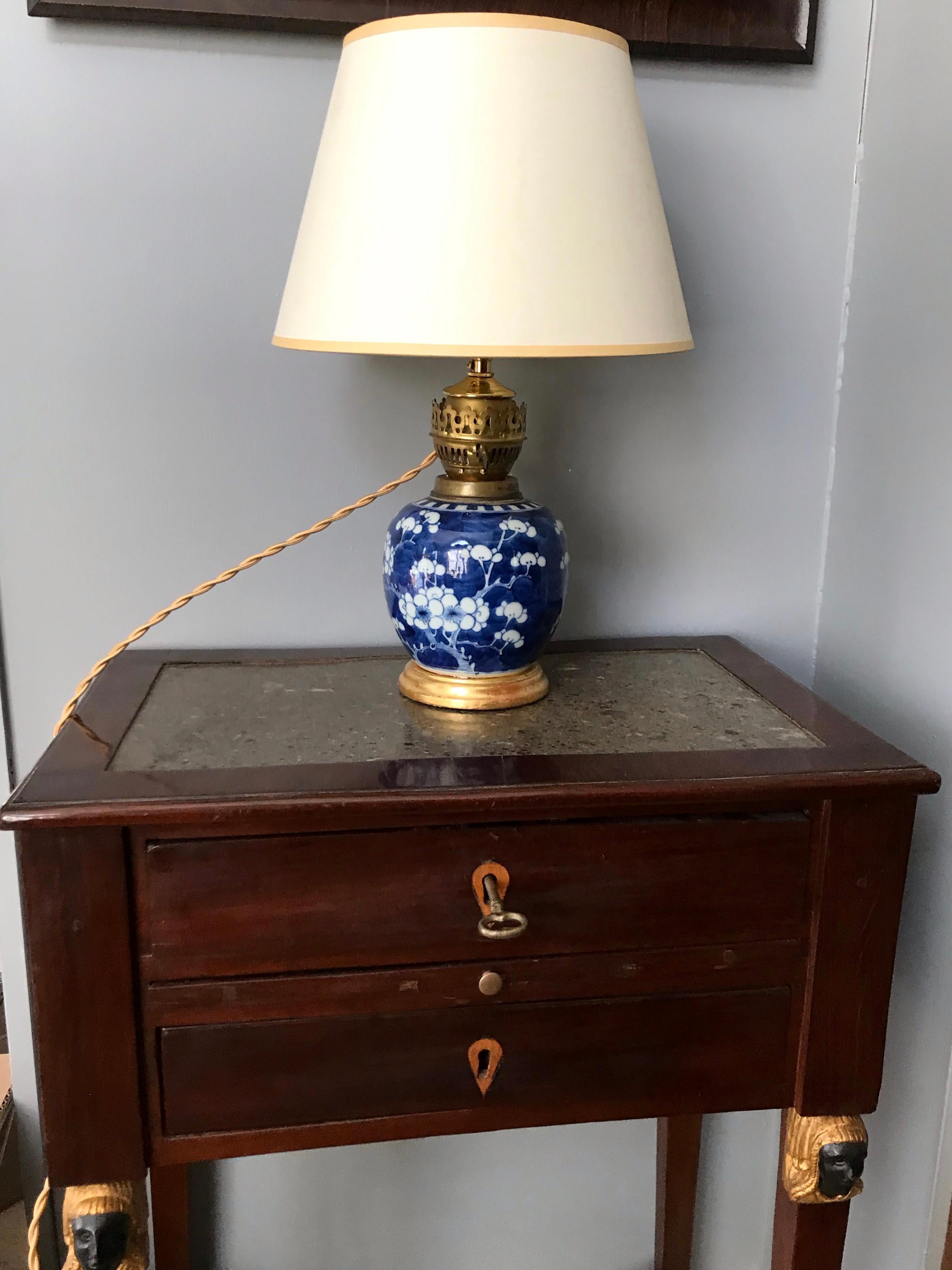 Blue and white cherry blossom vase lamp on gilt wood base. Late 19th Century hand-painted blue and white Chinese vase in the cherry blossom pattern mounted as a gas lamp in the late 1800's now converted to electric, fitted for a clip-on shade