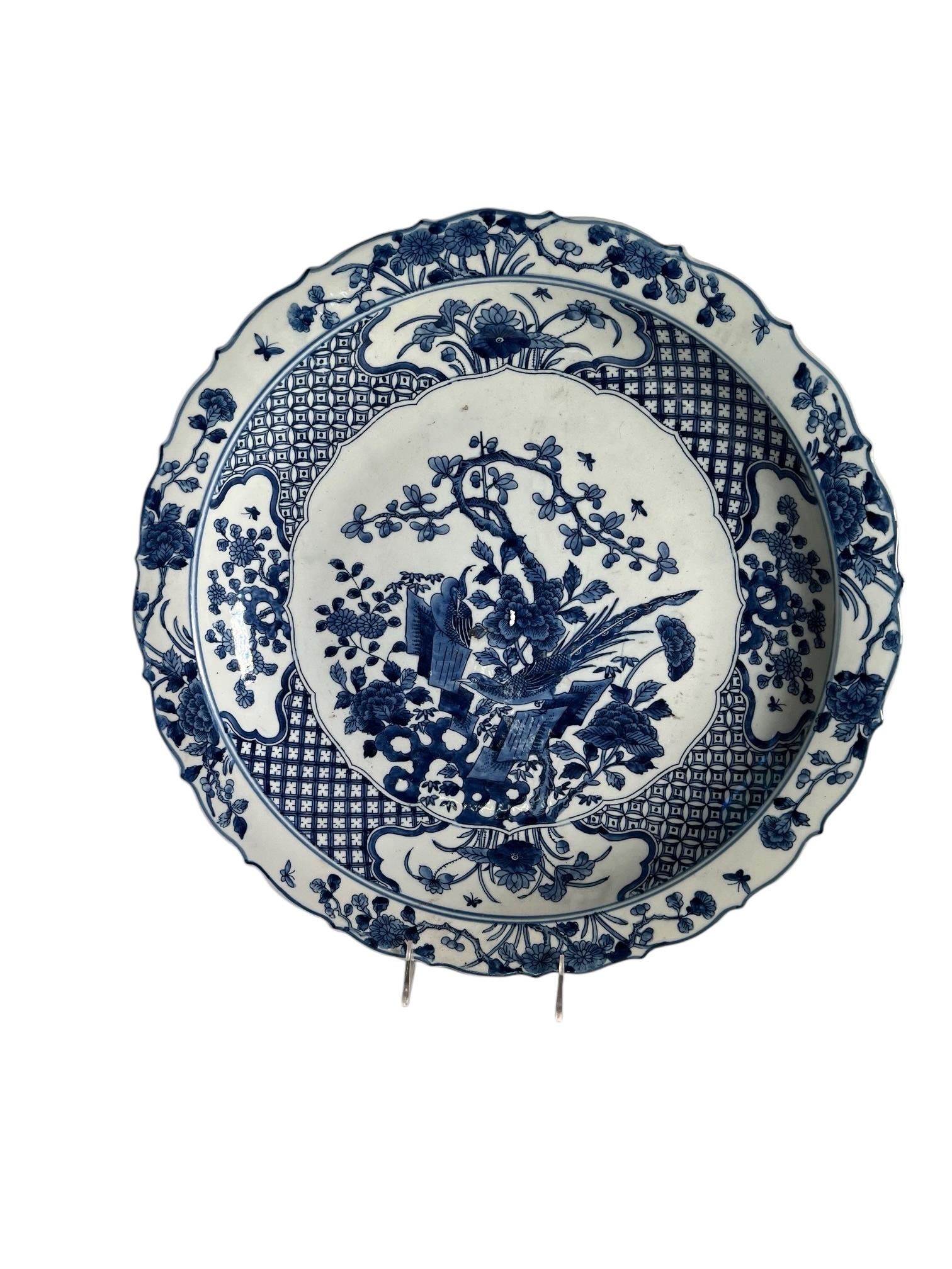 A pair of very pretty 21st century blue and white Chinese chargers with a floral design and scalloped edge. 