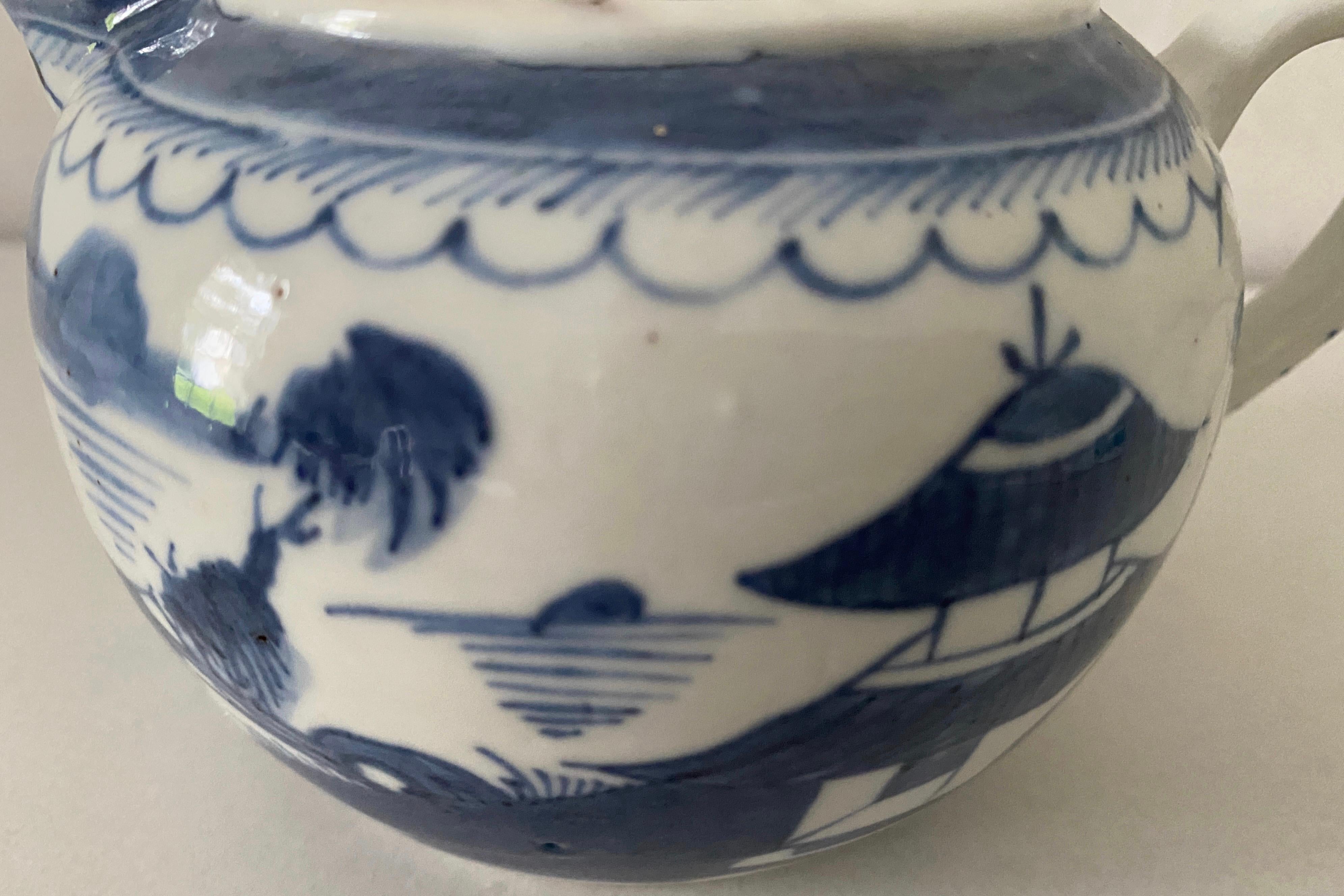 A Chinese Export blue and white small jug or pitcher decorated with Chinese landscape scenes featuring pagoda and nature elements.
   
  