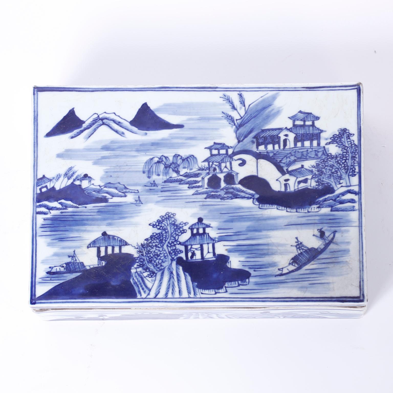Chinese export style blue and white porcelain box decorated with classic chinoiserie landscapes. The removable lid reveals an interior divided into six sections.