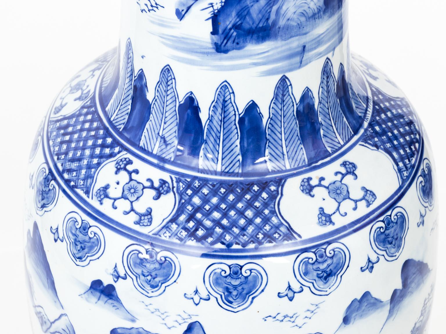 Large blue and white porcelain palace vase with scalloped edge and Chinese landscape scene on the body, circa 20th century.