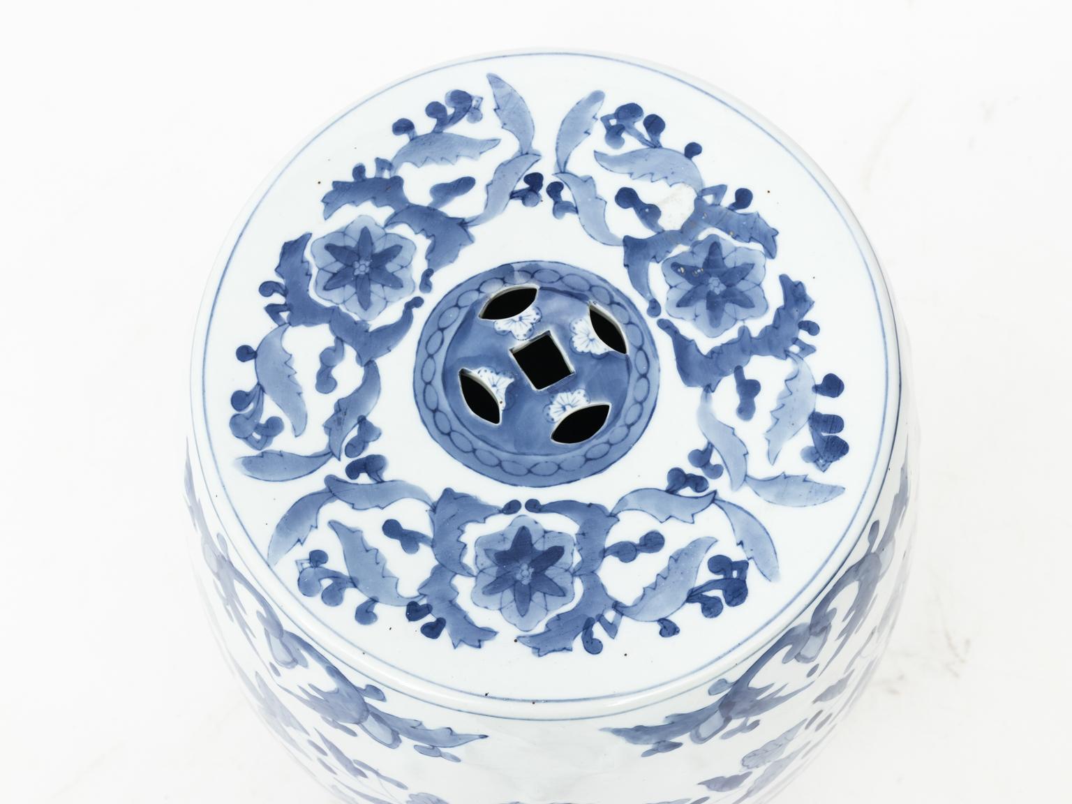 Blue and white Chinese porcelain garden seat with flower, phoenix, and dragon motifs, circa 20th century. Please note of wear consistent with age to the glazed finish.