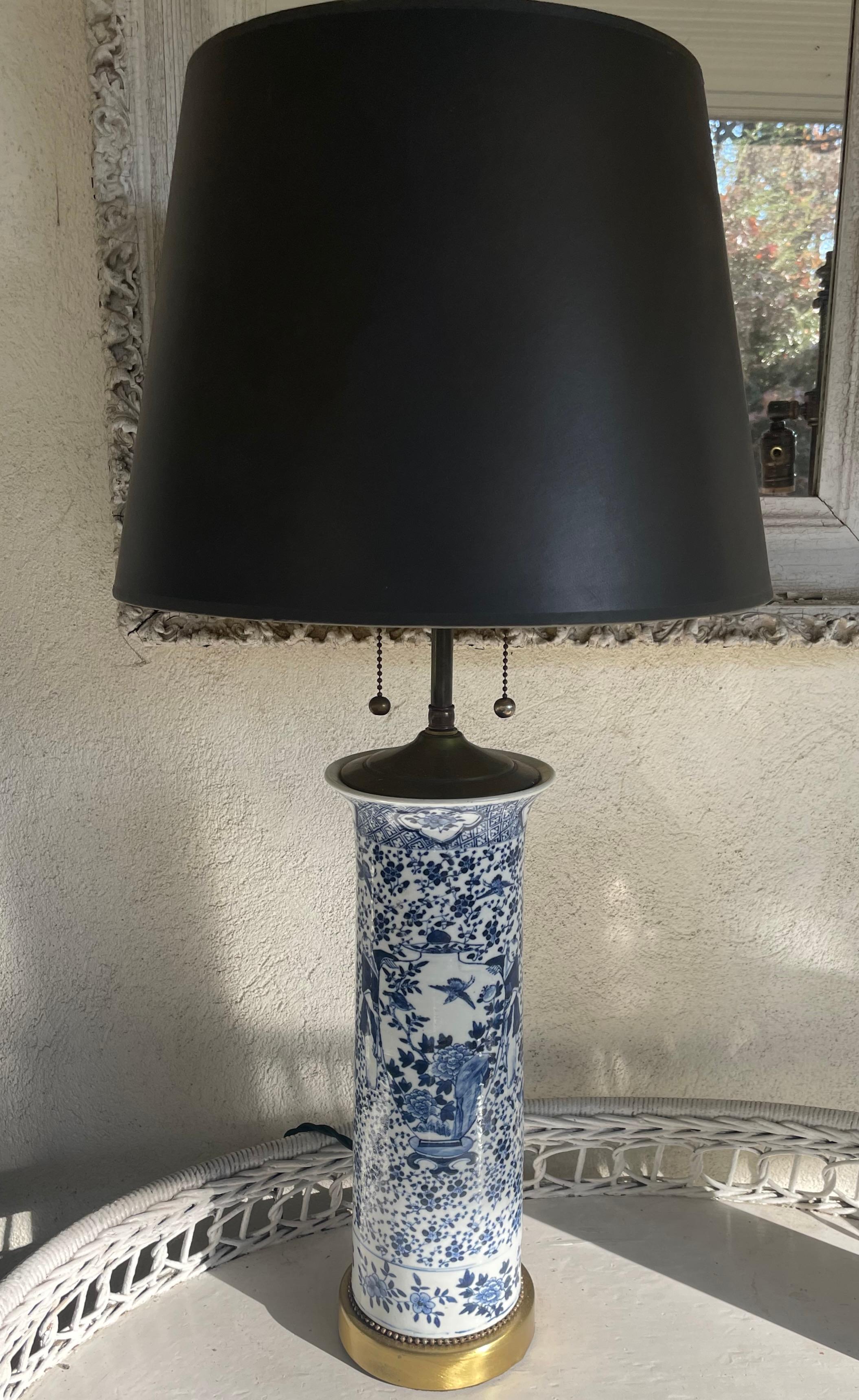 Blue and white Chinese trumpet vase lamps. Pair of tall cylindrical shaped trumpet vases in bright blue and white with Mandarin figures presenting an imperial scale vase with birds flying through floral background and diapered banding with floral