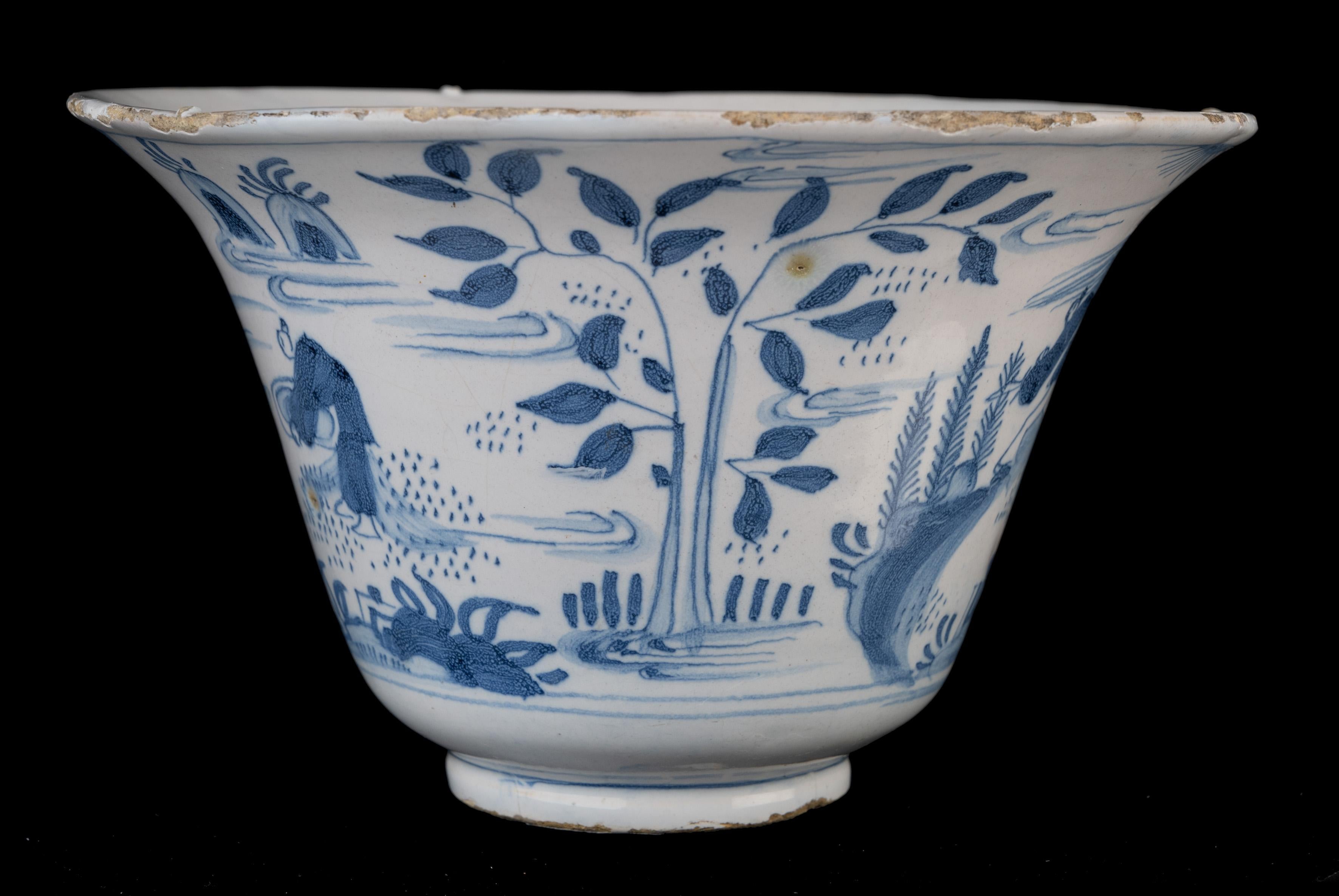 Blue and white chinoiserie bowl Delft, 1660-1680

The blue and white bowl stands on a foot, has a high, strongly cantilevered wall and is painted all round with three Chinese men with a banner and other attributes in a chinoiserie landscape. On