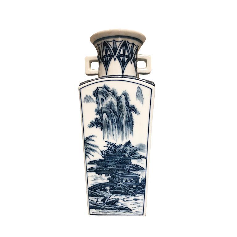 Chinoiserie blue and white porcelain vase. Featuring a square base, and round top. Each side features various flora and fauna scene as well as a small diamond pattern. Sides have two small handles. Made in Japan. Would be a gorgeous addition to a