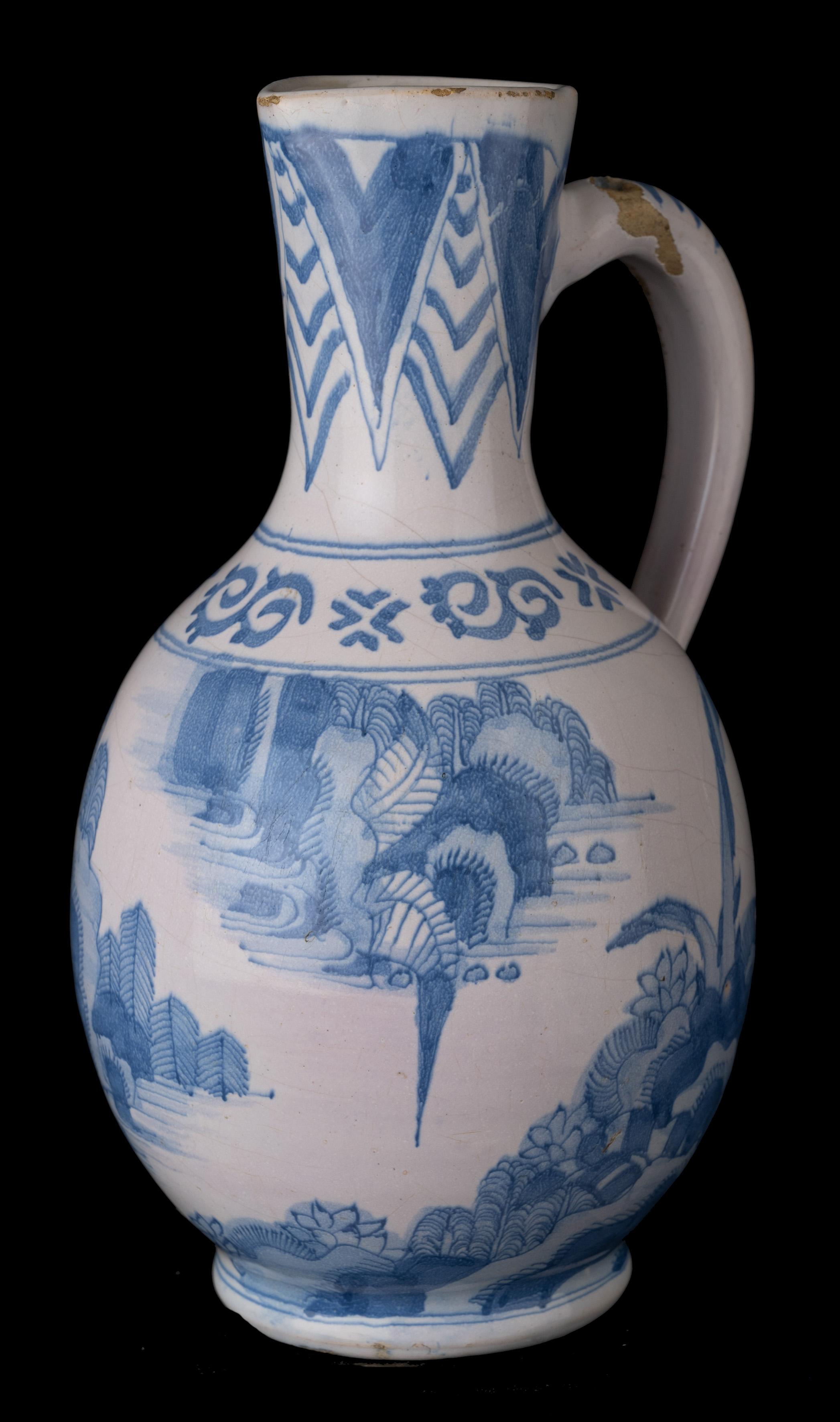 Blue and white chinoiserie wine jug Delft, 1650-1670 

The ovoid-shaped wine jug stands on a waisted foot and has a slightly conical neck with a spout and an ear-shaped handle that ends in a rat tail. The top of the handle is pierced for a metal