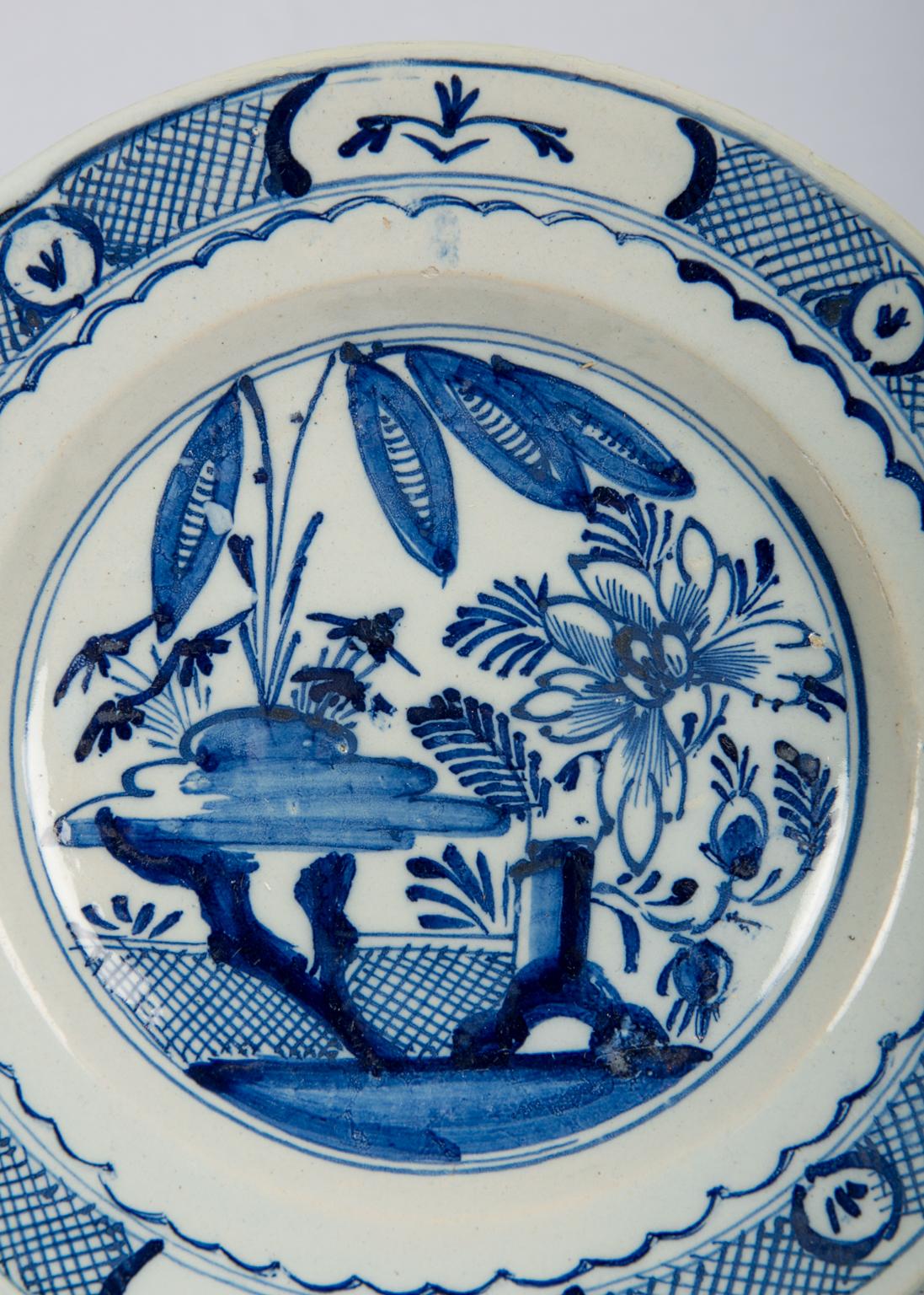 We are pleased to offer this set of six blue and white delft dishes made in The Netherlands in the last quarter of the 18th century. The dishes are decorated in several shades of cobalt blue. The center of each dish shows a garden scene. We see an