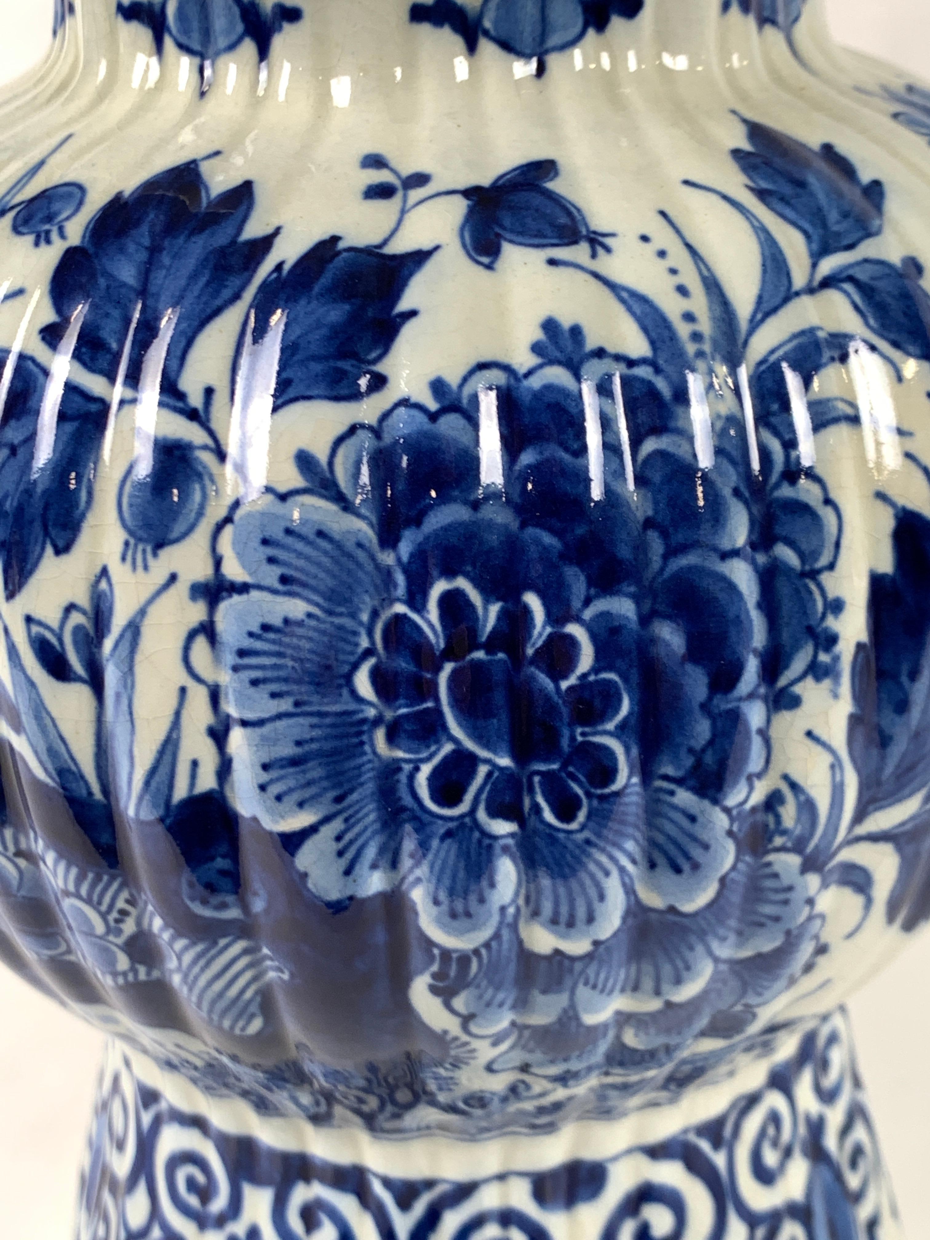 This blue and white jar is a hand-painted gem of mid 20th century Delft.
 What makes this jar so exceptional is the exquisite deep rich blue painting.
Made by De Porceleyne Fles, this lovely jar is beautifully decorated with flowers, rockwork, and