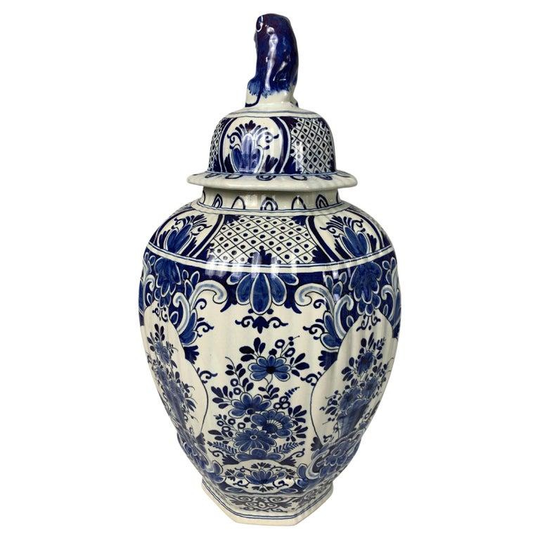 This large blue and white Delft jar is painted showing beautiful blue flowers on a traditional white tin-glazed ground.
The shoulders and cover were also decorated in a traditional style with floral panels separated by 