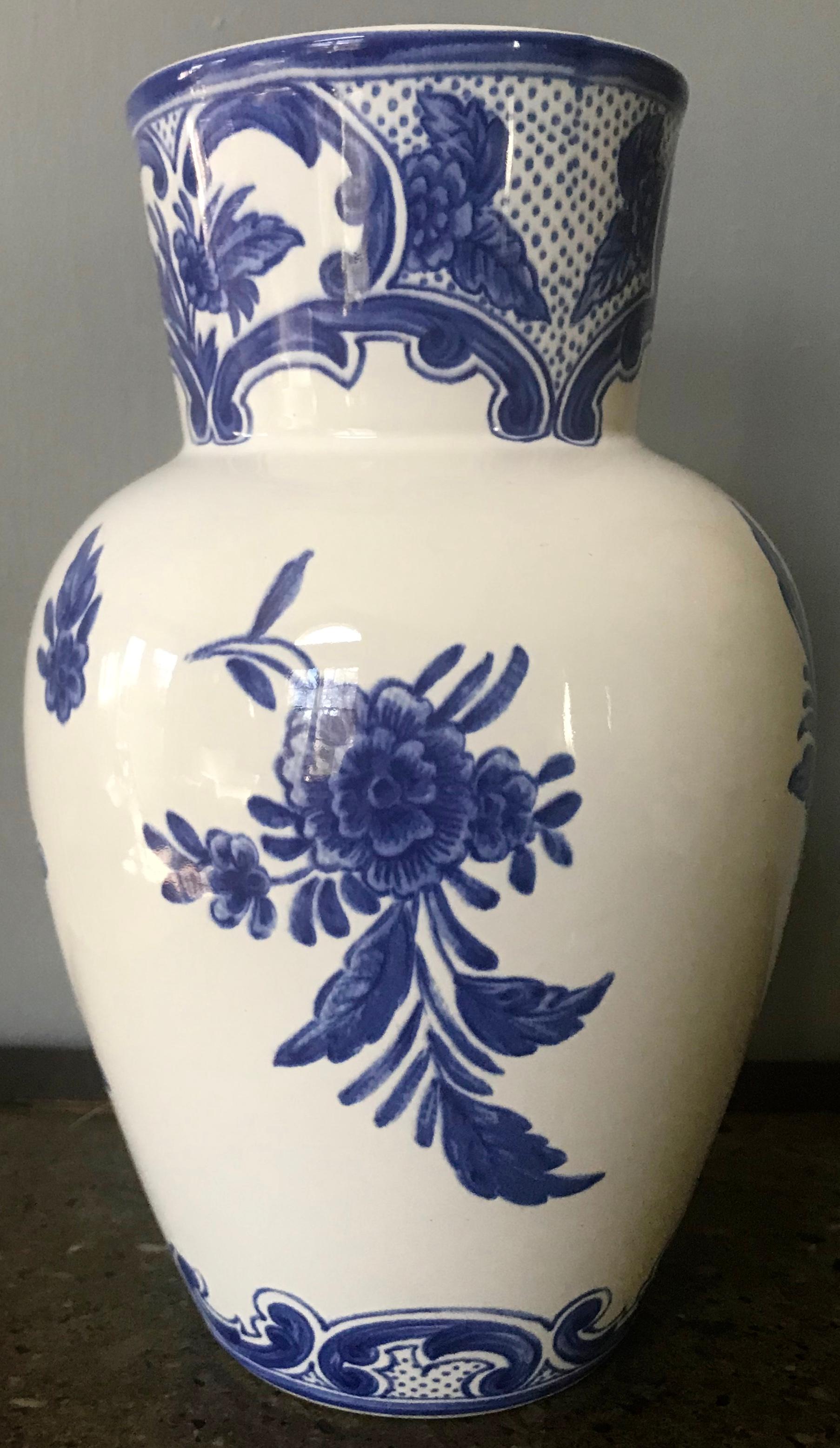 Blue and white Delft Tiffany & Co. vase. Tall glazed white and blue pottery collared vase with floral sprigs and Delft style decorations. Made for Tiffany & Co. Portugal, 1996.
Dimensions: 4