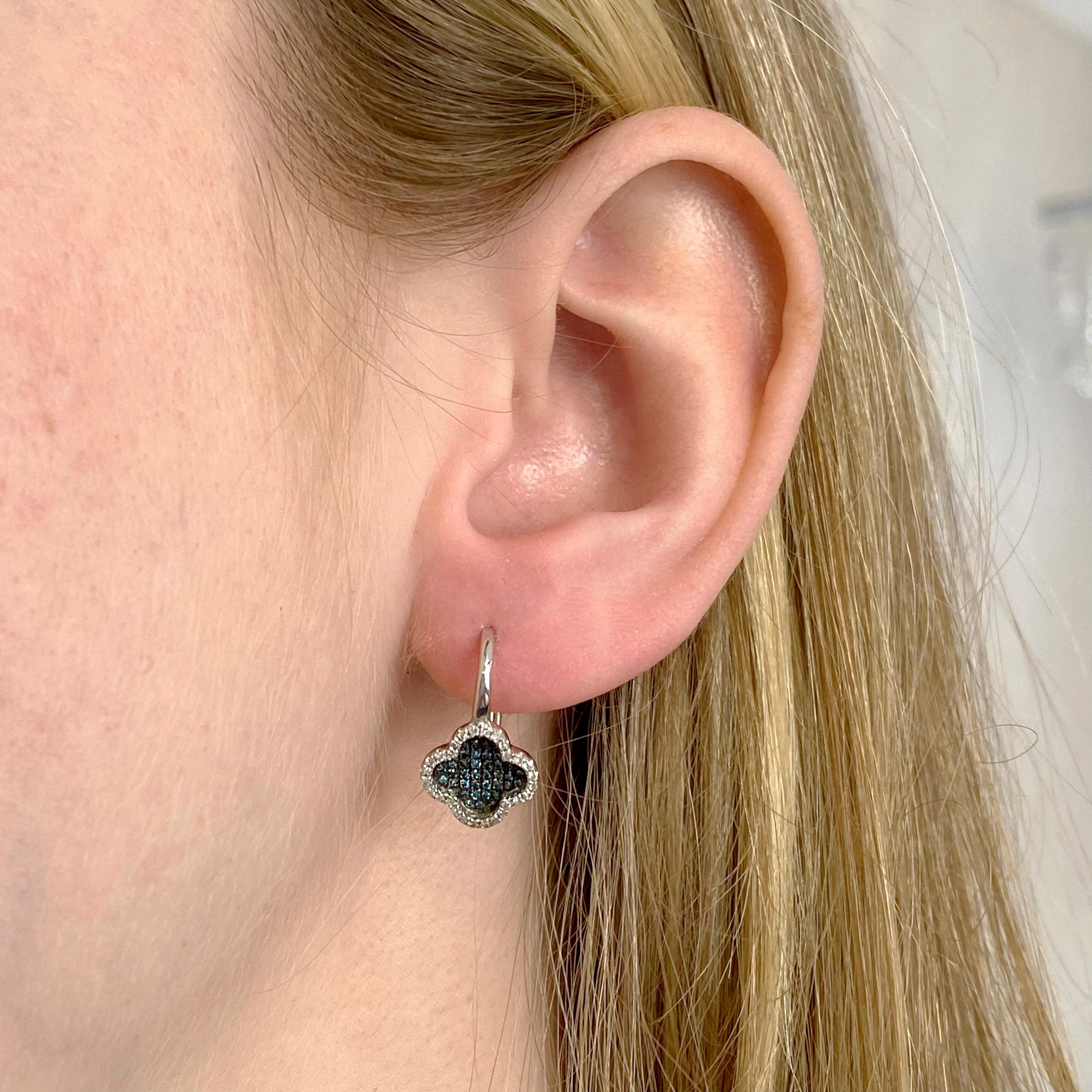 These dangle earrings are are very unique. Showcasing both blue and white diamonds that are incredibly eye catching and the clover shape of these earrings is what makes this piece special. The details for these gorgeous earrings are listed