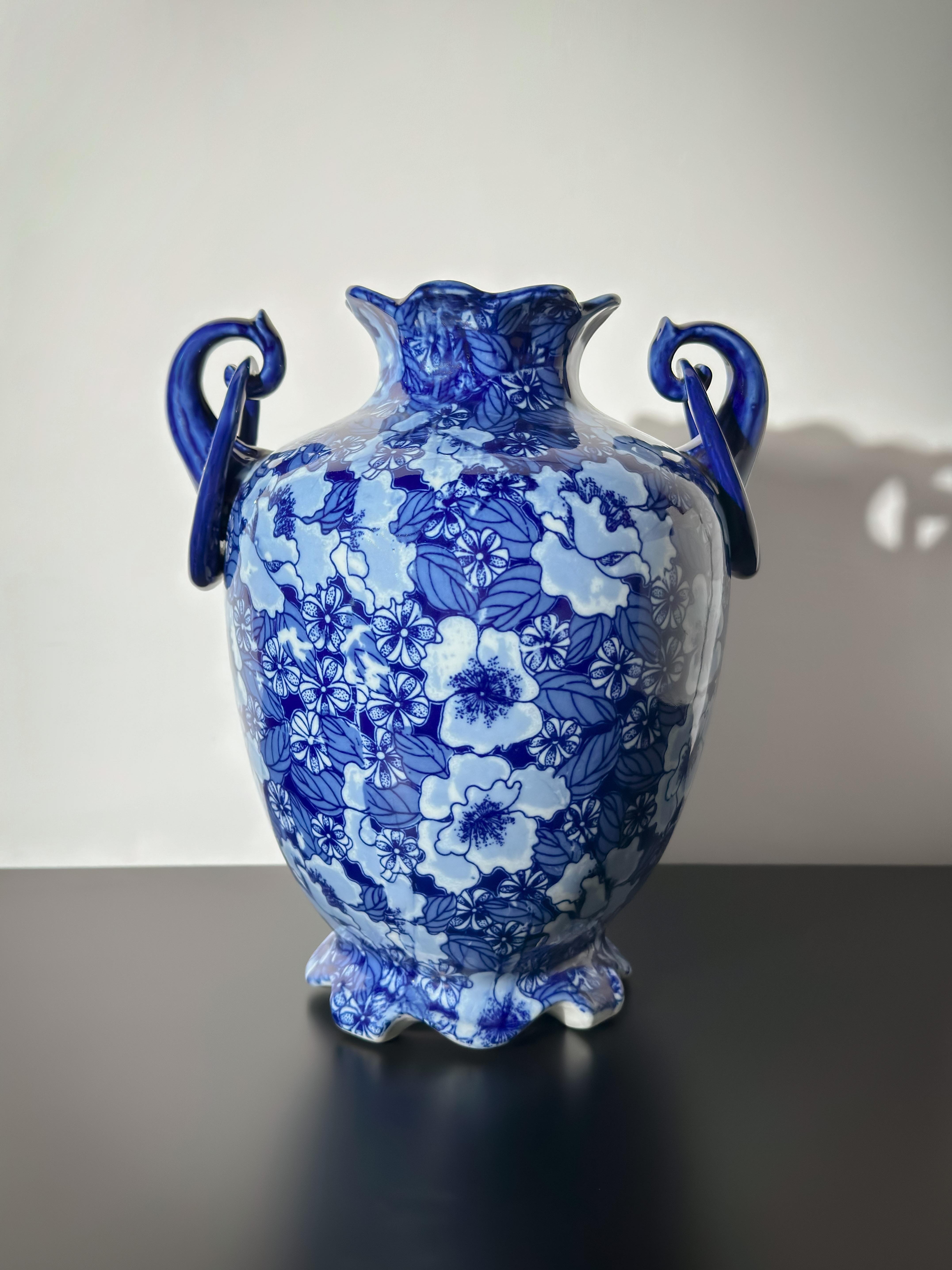 A double-handled urn vase by Regency Ironstone, England, likely produced mid-20th century and inspired by 19th-century Mason’s Ironstone designs. 

The piece features a deep cobalt blue enamel glaze decorated with a  floral chintz pattern against