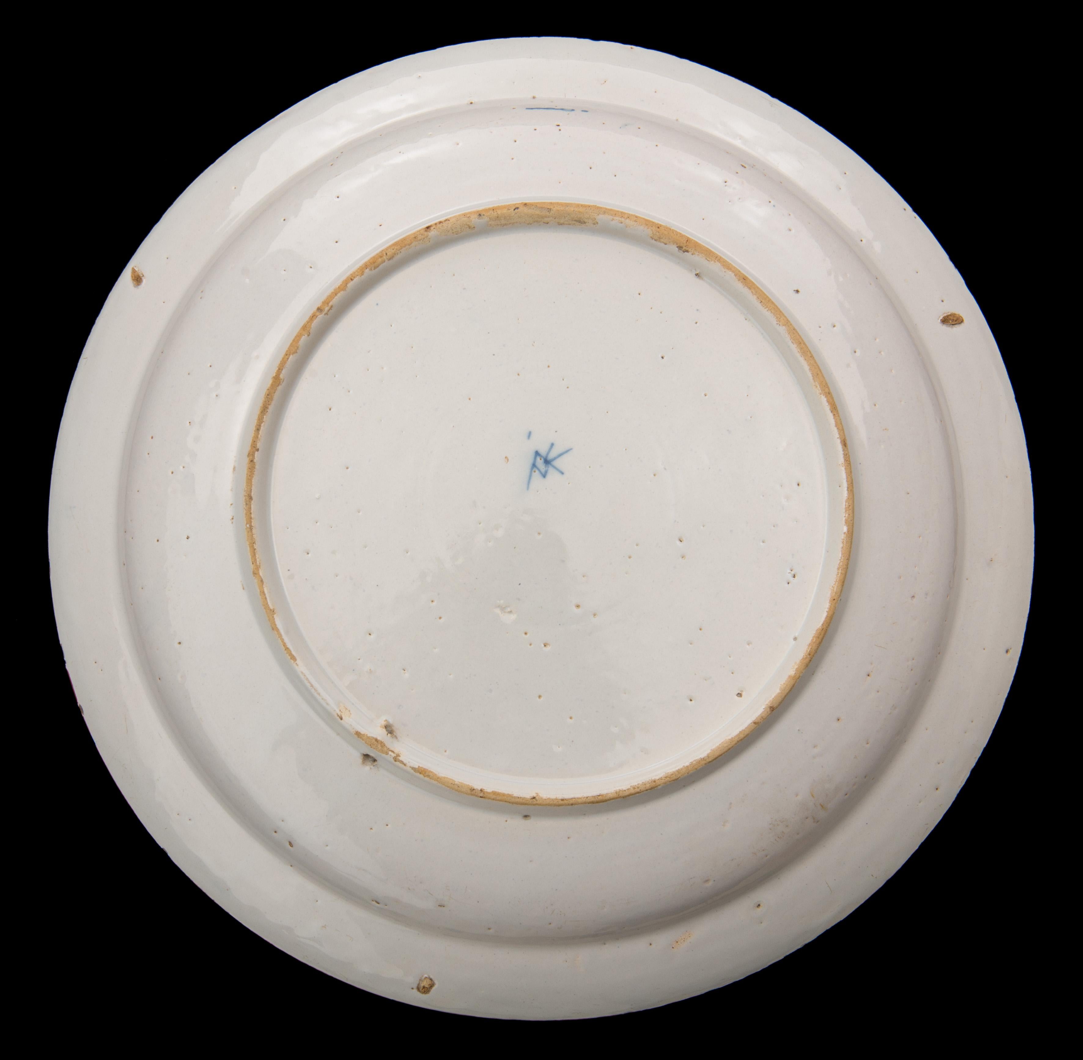 Blue and white dragon dish. Delft, 1722-1757
The Greek A pottery
Mark: AIK, period of Jacob van der Kool (1722-1757)

Dish with blue and white decoration of a dragon on a dense ground of flowers and foliage. The well is undecorated. The border is