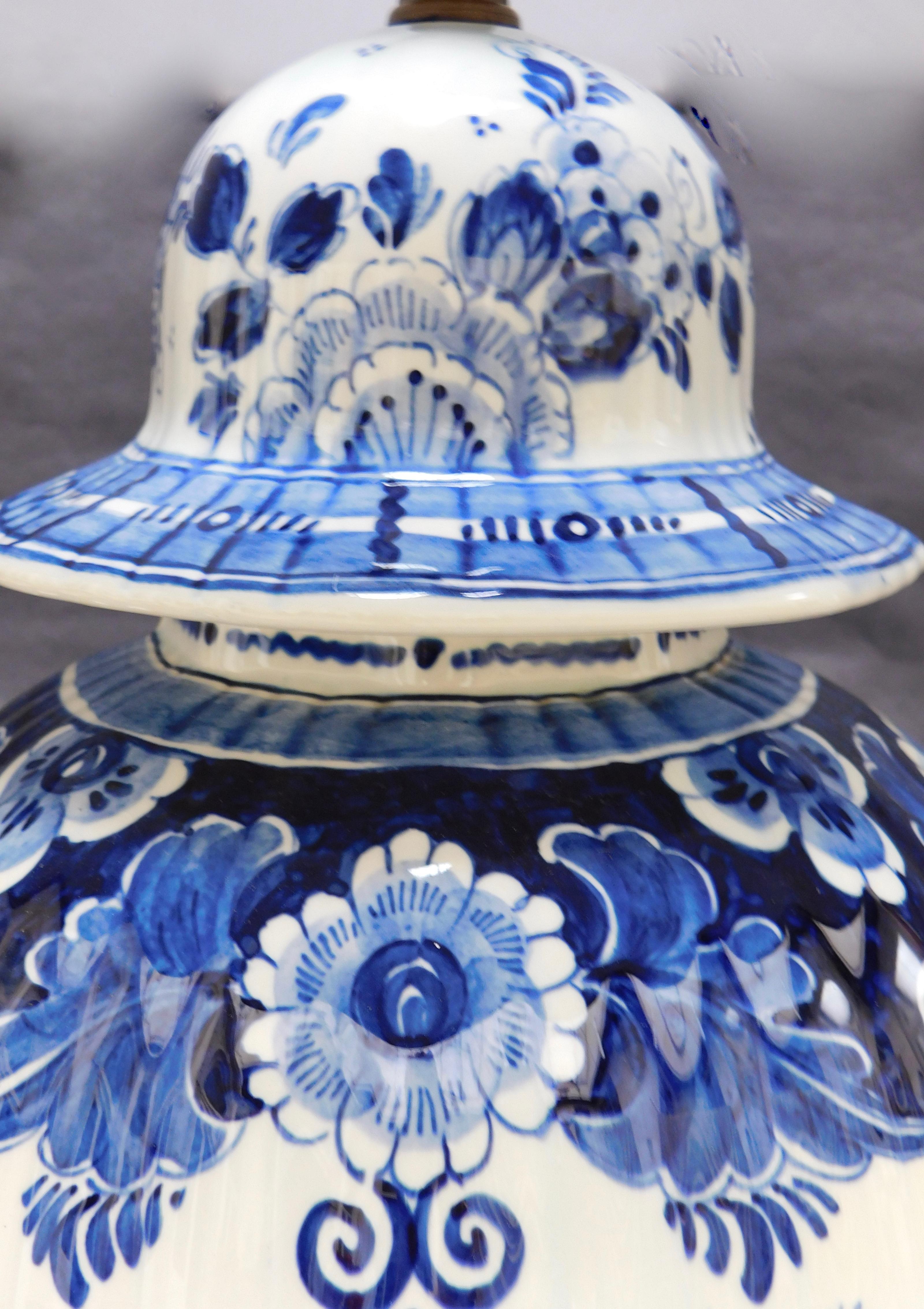 A vintage blue and white ceramic Delft urn hand-painted in Delft Holland. The pattern is classically Dutch from the 
