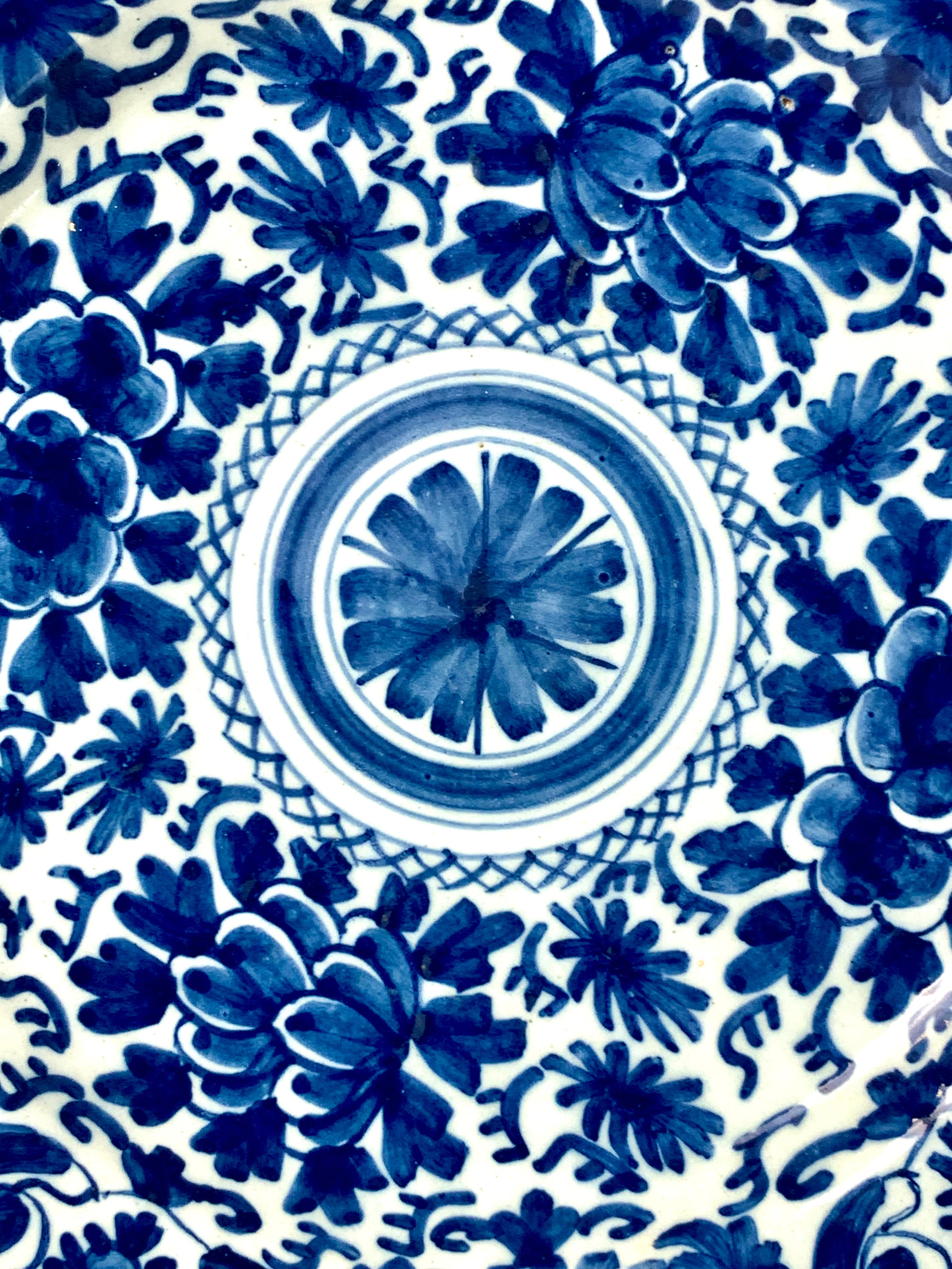 This blue and white Delft charger was hand painted in the Netherlands in the 18th century, circa 1780.
The decoration features a traditional Dutch Delft design of scrolling vines and tulips around a central medallion.
The charger is painted in an