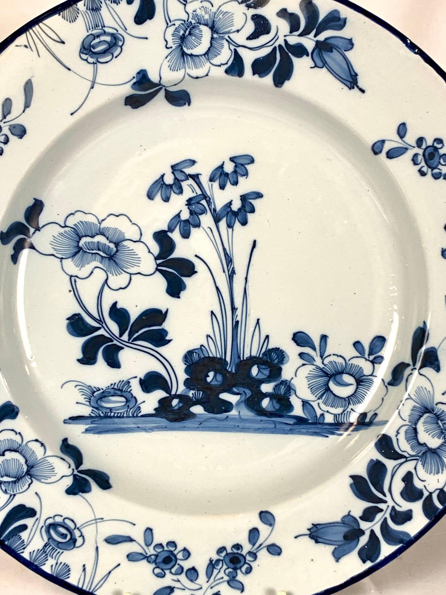 This blue and white Dutch Delft charger was hand painted in the mid-18th century, circa 1760.
The artist has created a lovely garden scene using two shades of cobalt blue.
The simple but elegant decoration features flowers in full bloom, leaves, and