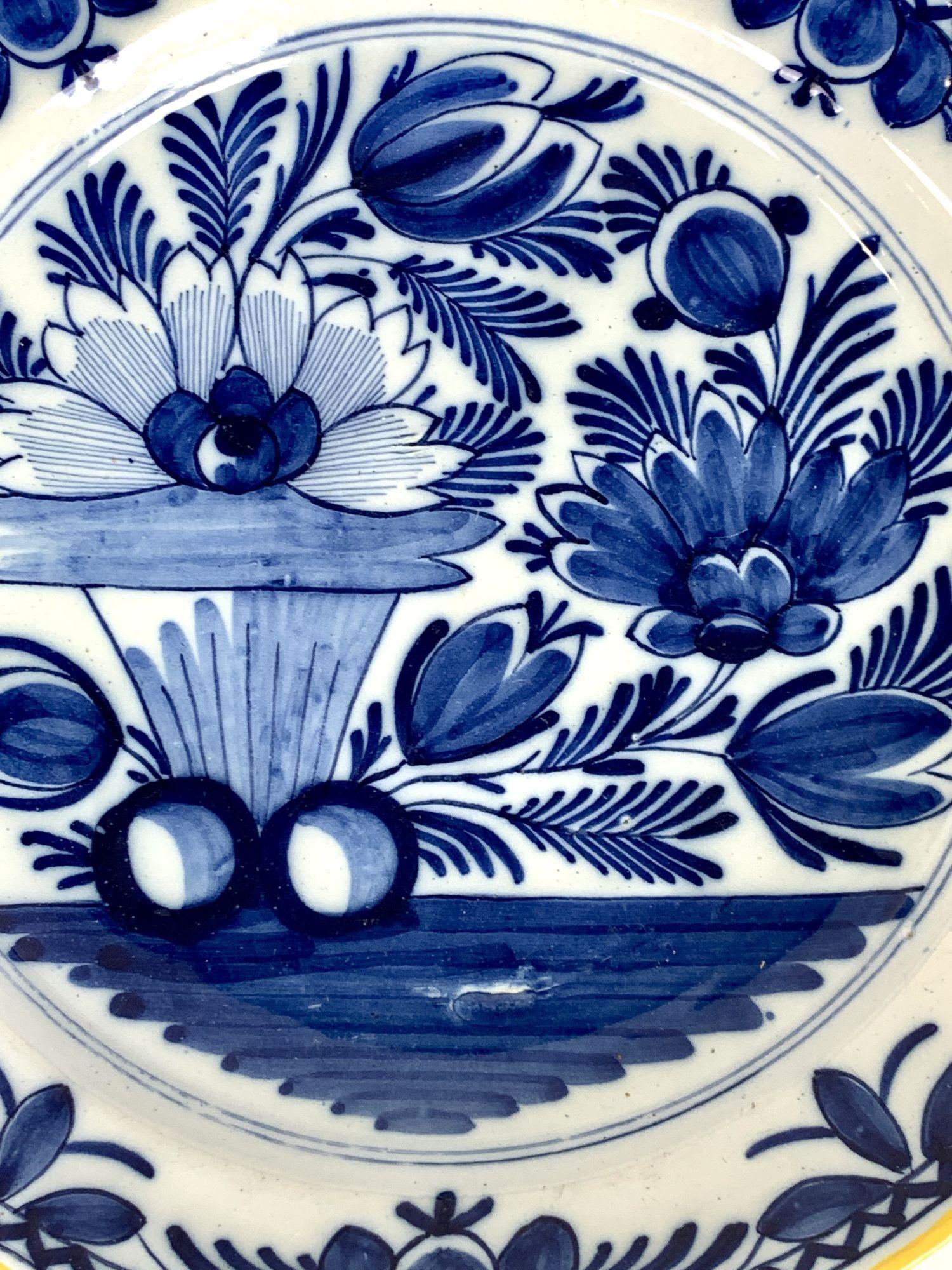 Made in the Netherlands circa 1800 this antique blue and white Dutch Delft charger has beautiful cobalt blue coloring.
The center shows a garden with tulips, peonies, and a water lily above rocks.
The bright cobalt blue is splendid on the bright