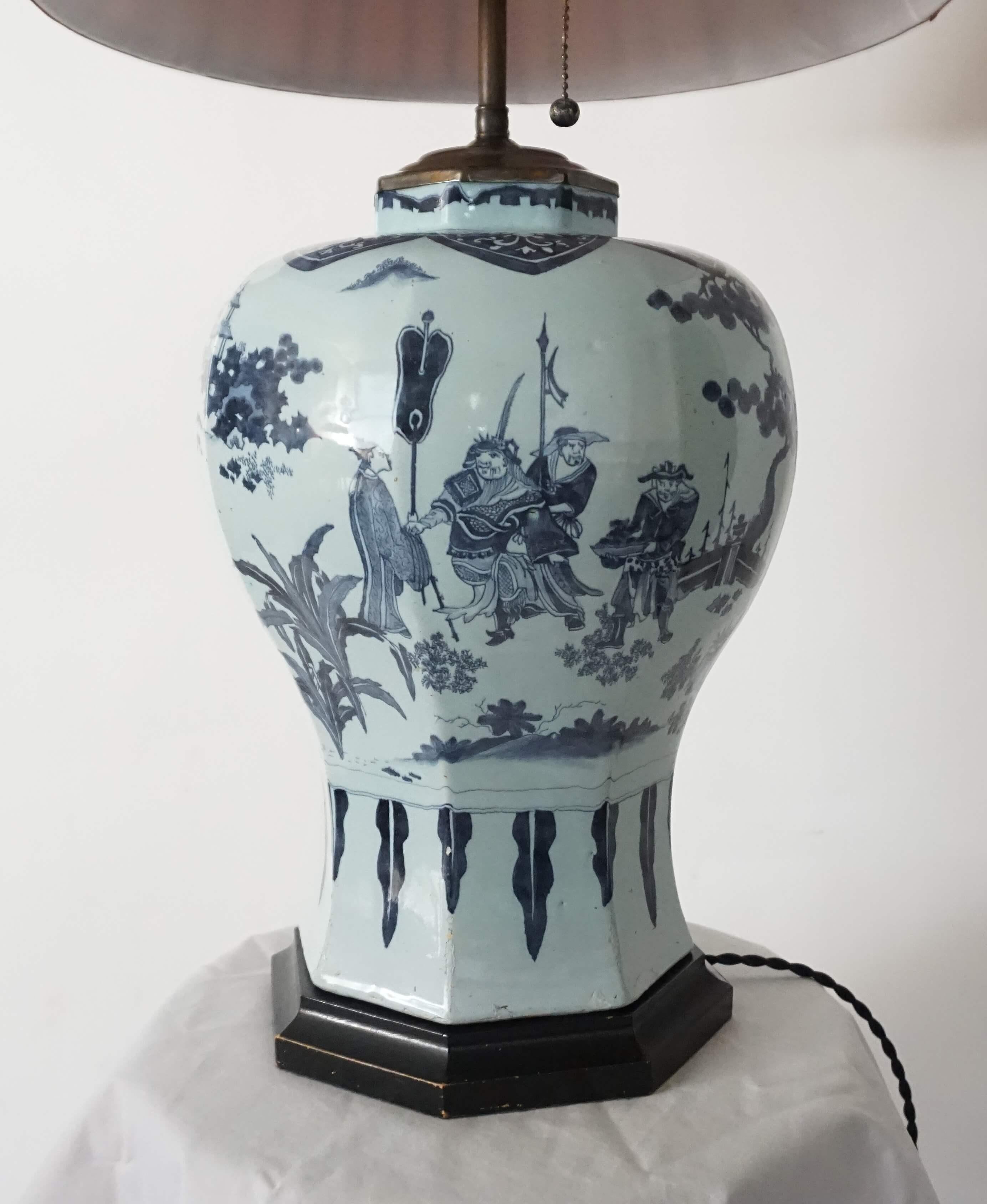 A large circa 1670 Dutch delft octagonal baluster form vase having all-over underglaze blue Ming-style chinoiserie landscape and figural designs on bluish-white body converted for use as a table lamp with patinated brass fittings and black-painted
