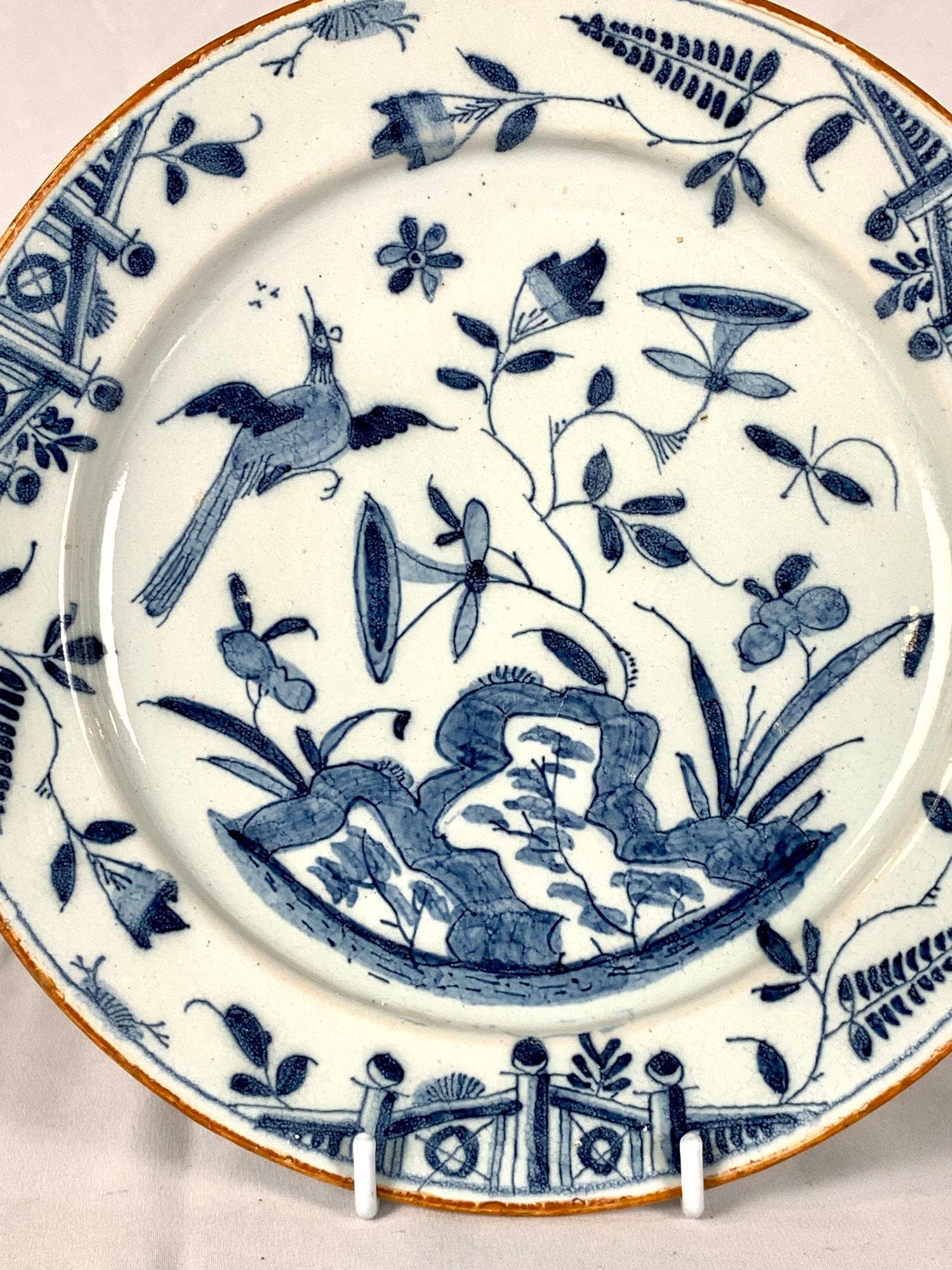 This beautiful blue and white delftware dish was hand painted in England around 1760.
It features a lively garden scene with a butterfly hovering on one side and a songbird in flight her head tilted up in song on the other.
The scene is set against