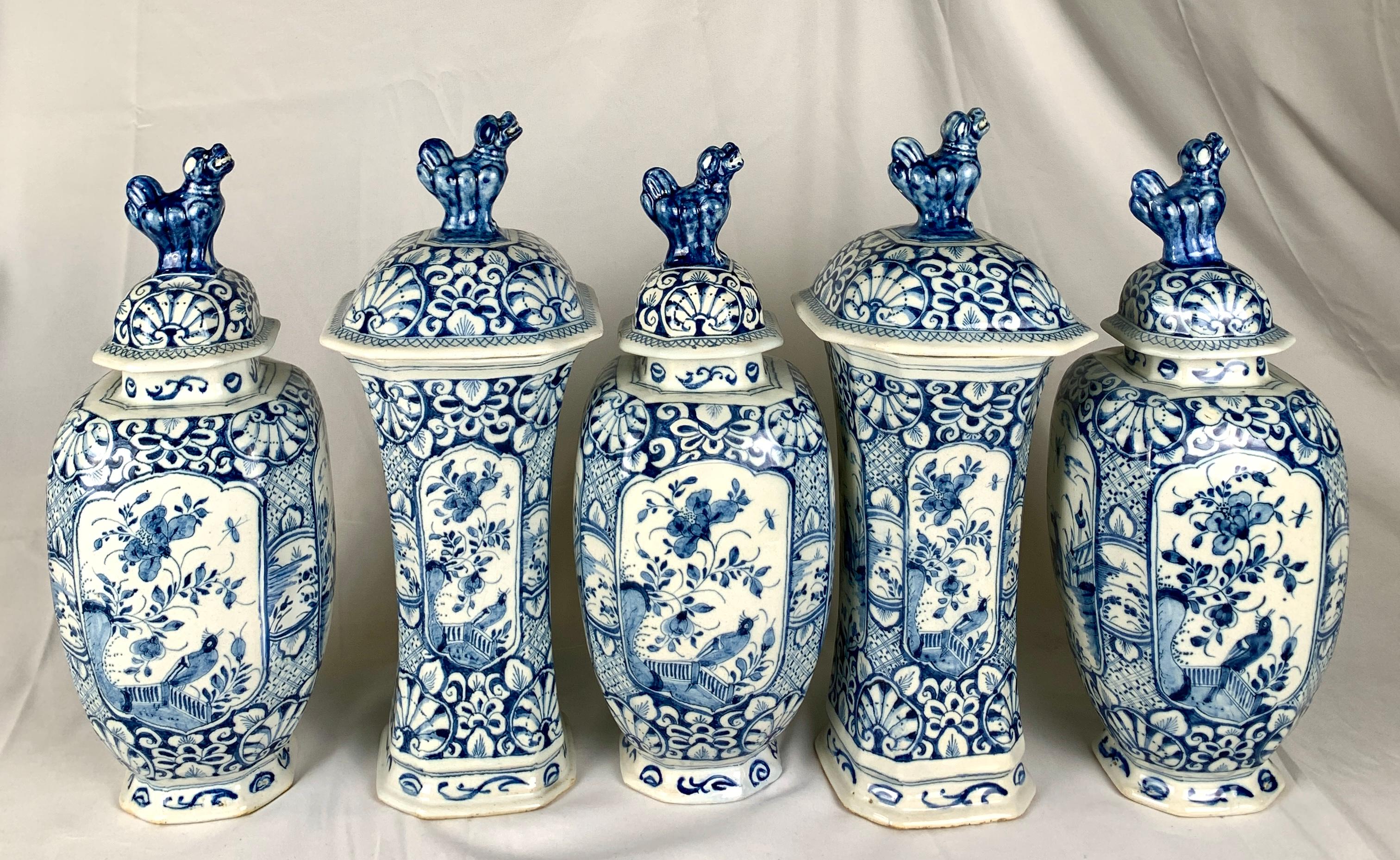 This exquisite blue and white Delft five-piece garniture from mid-18th century Holland, circa 1760, is a masterpiece. The hand-painted panels on the front and back of each jar are decorated with a tranquil scene showing a deer and a butterfly in a