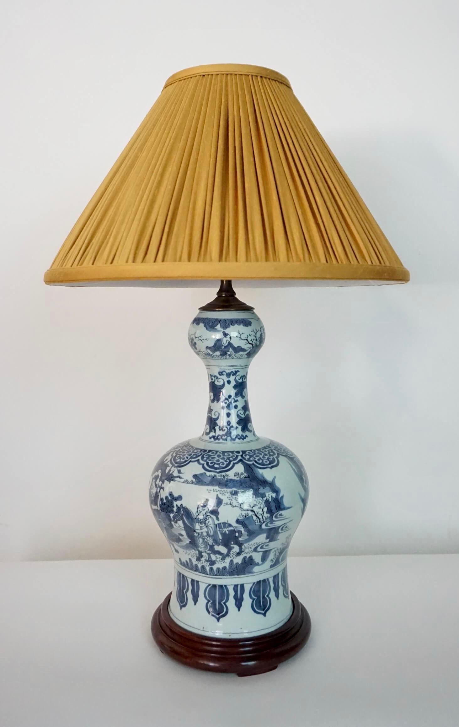 Beautiful circa 1700 Dutch delft vase of round 'garlic-neck' form having blue figural landscape decoration under tin-glaze in 'transitional' Ming style; converted for use as a table lamp with patinated brass fittings and wood base. Vase alone