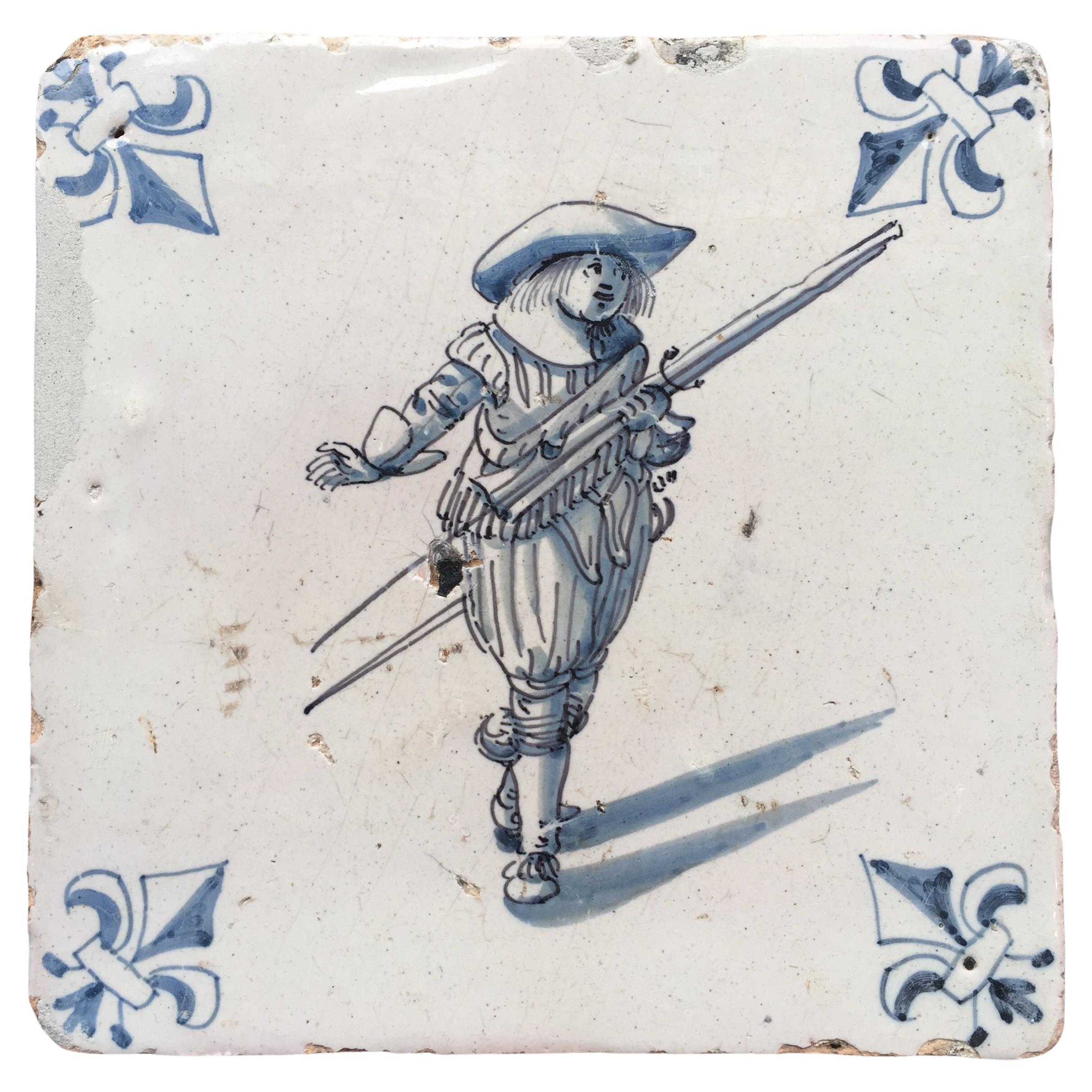 Blue and White Dutch Delft Tile with Musketeer, Mid 17th Century For Sale