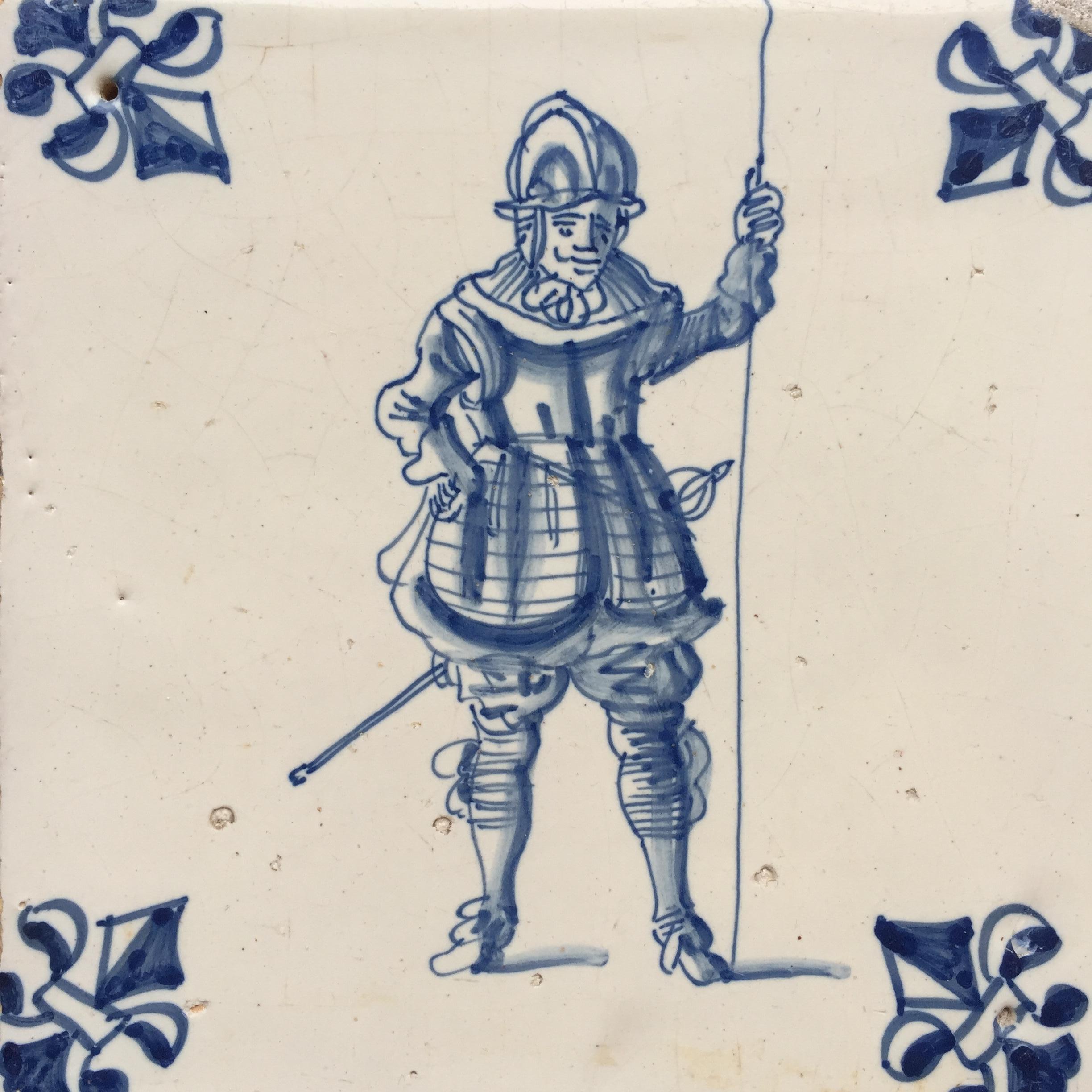 The Netherlands
Amsterdam
Circa 1625 – 1650

A blue and white Dutch tile with a decoration of a Dutch or Spanish soldier from the period of the 80 Years War.
The decoration of this tile is very detailed and we can beautifully see the details in his