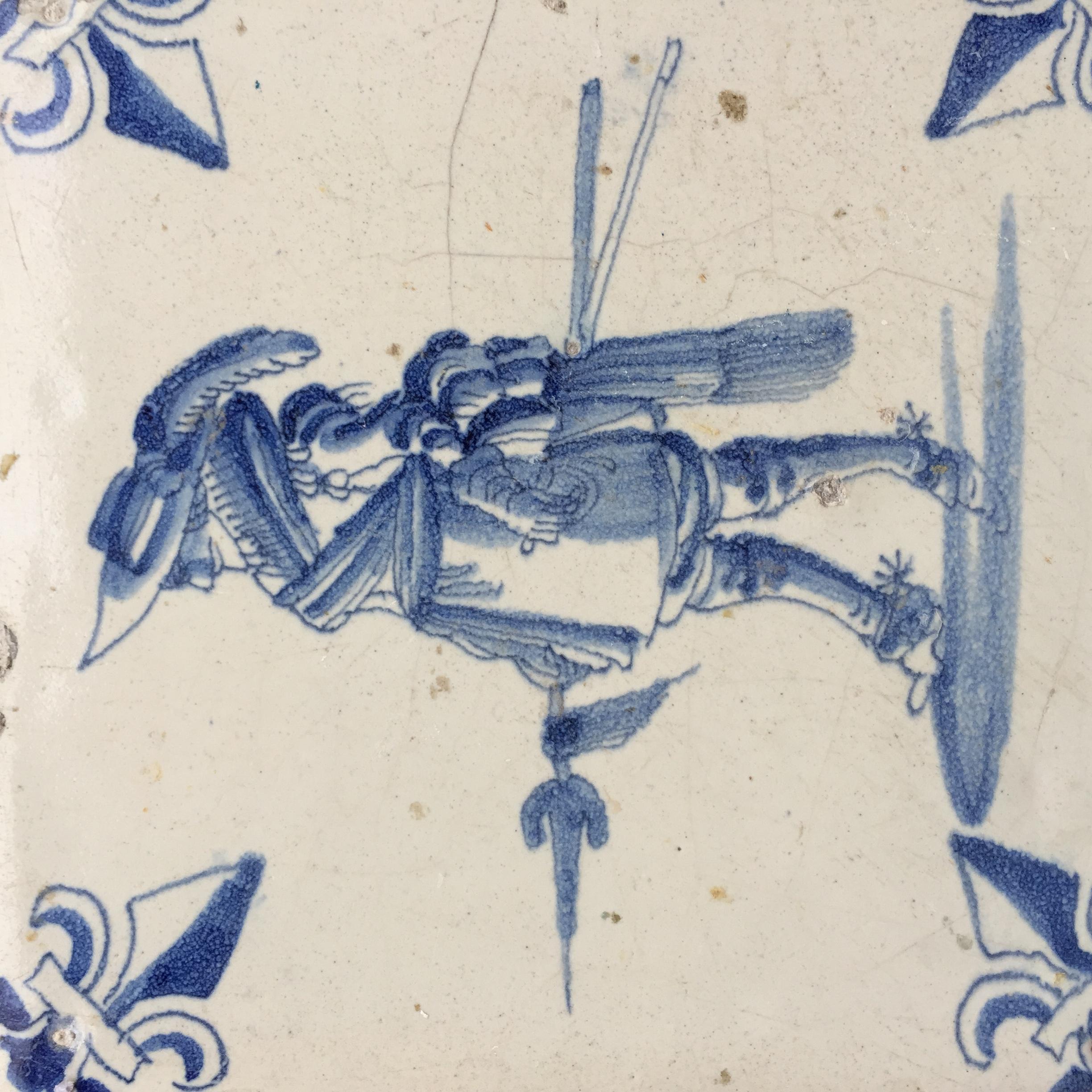 The Netherlands
Amsterdam
Circa 1625 – 1650

A blue and white Dutch tile with a decoration of a Dutch soldier from the period of the 80 Years War. This soldier could be a member of the civil guard, and is probably wearing a ceremonial costume. He is